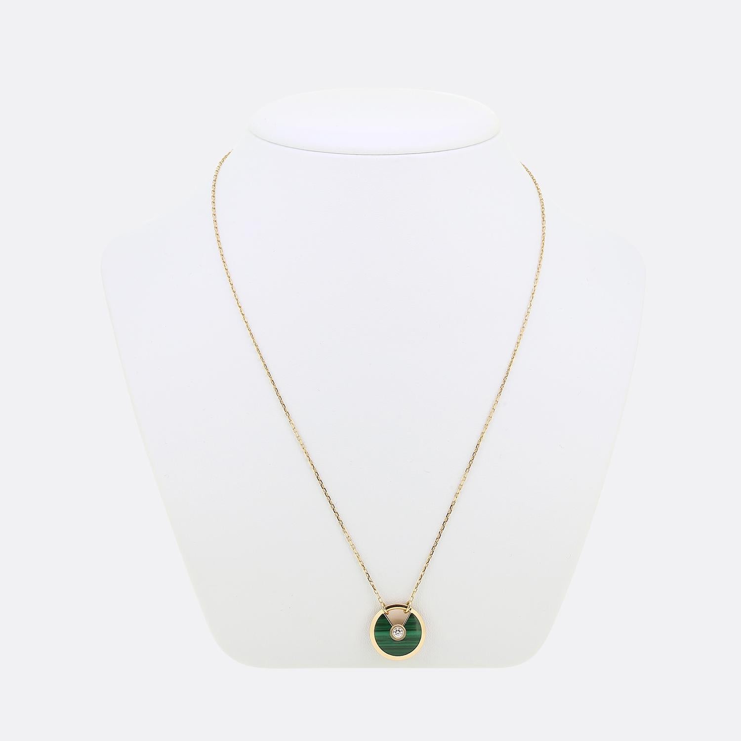 Here we have a fabulous necklace from the world renowned jewellery house of Cartier. This pendant forms part of their iconic 'Amulette' collection and features a single round brilliant cut diamond atop a malachite backdrop with a padlock opening to