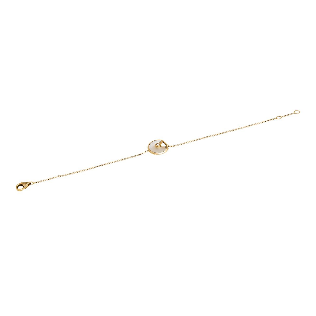 A magnificent offering from Cartier's Amulette de Cartier line. The bracelet comes crafted from 18k yellow gold and it has the signature motif in mother of pearl highlighted by a shimmering diamond. Smoothly finished, the desirable creation deserves