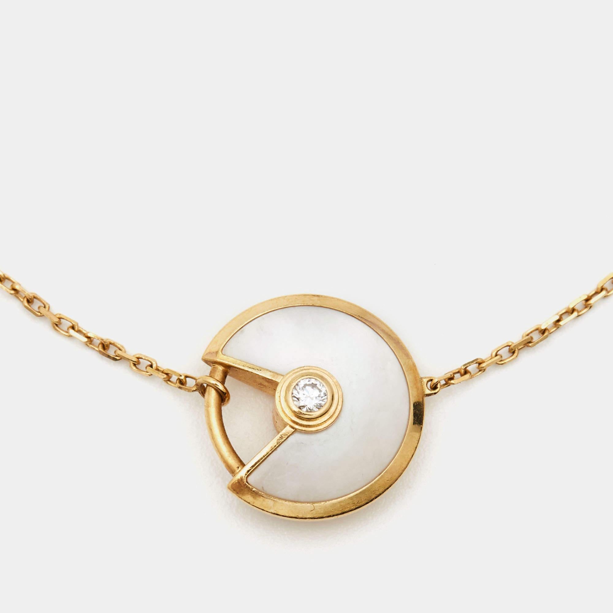 A magnificent offering from Cartier's Amulette de Cartier line. The bracelet comes sculpted from 18k yellow gold, and it has the signature motif in mother of pearl highlighted by a shimmering diamond. Smoothly finished, the desirable creation