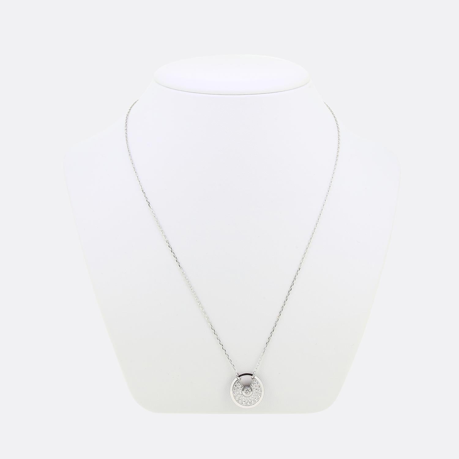 Here we have a delightful necklace from the world renowned jewellery house of Cartier. This pendant forms part of their iconic 'Amulette' collection and features a single round brilliant cut diamond atop a pavé diamond set backdrop with a padlock