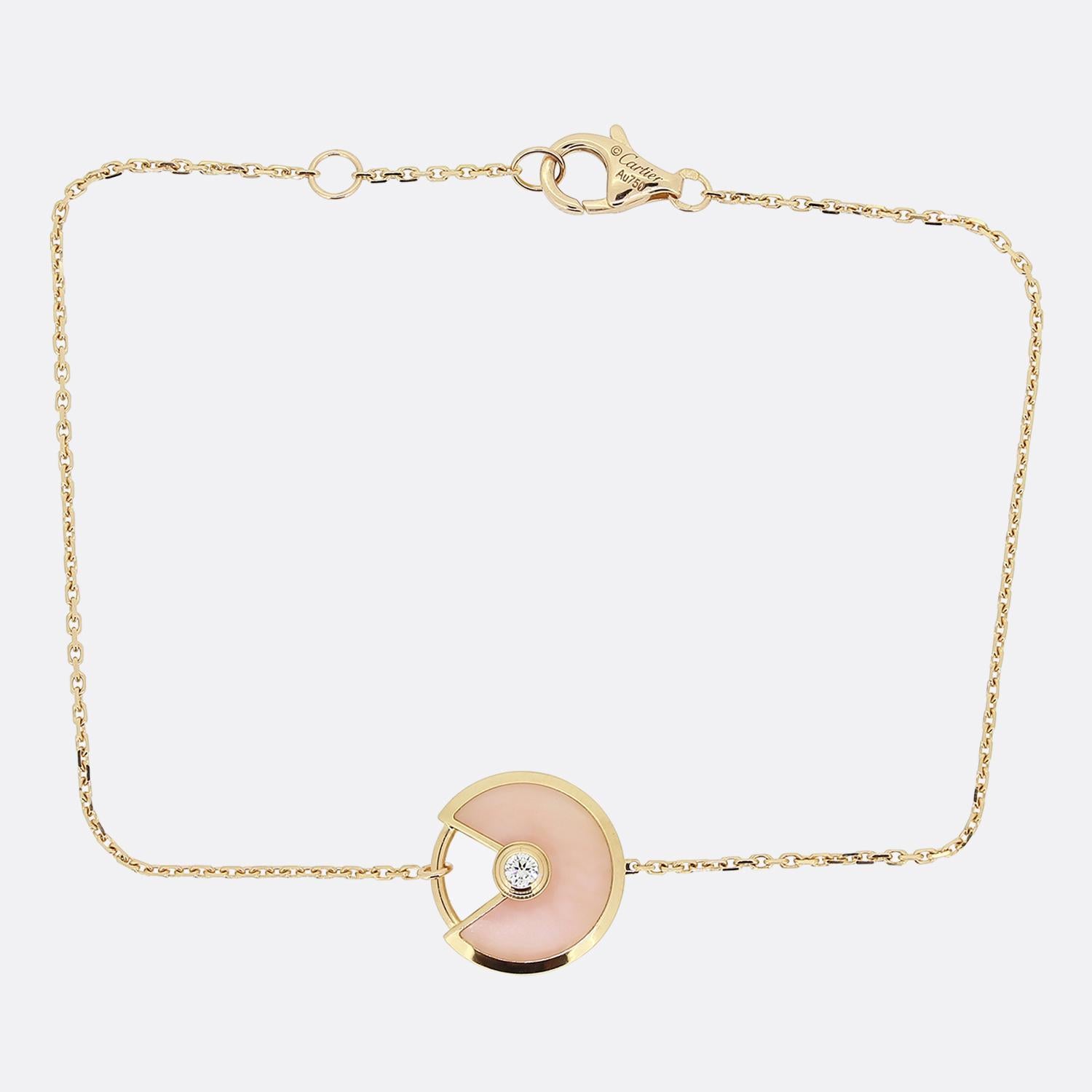 Here we have an elegant 18ct rose gold bracelet from the world renowned luxury jewellery house of Cartier. This piece forms part their Amulette de Cartier collection and showcases the iconic motif in pink opal with a small opening to one side and a