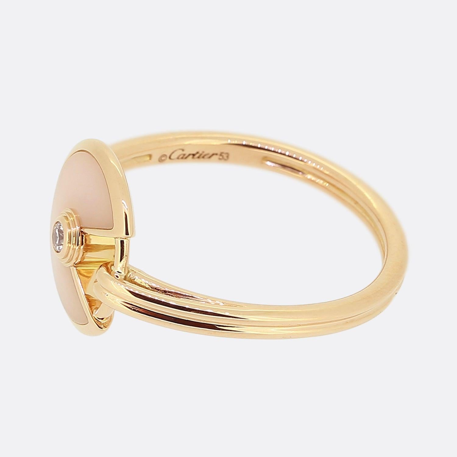 Here we have a distinctively stylish piece from the world renowned luxury jewellery house of Cartier. This ring forms part of their Amulette collection and is composed of baby pink opal at the face which is encased in a subtle rose gold bordering