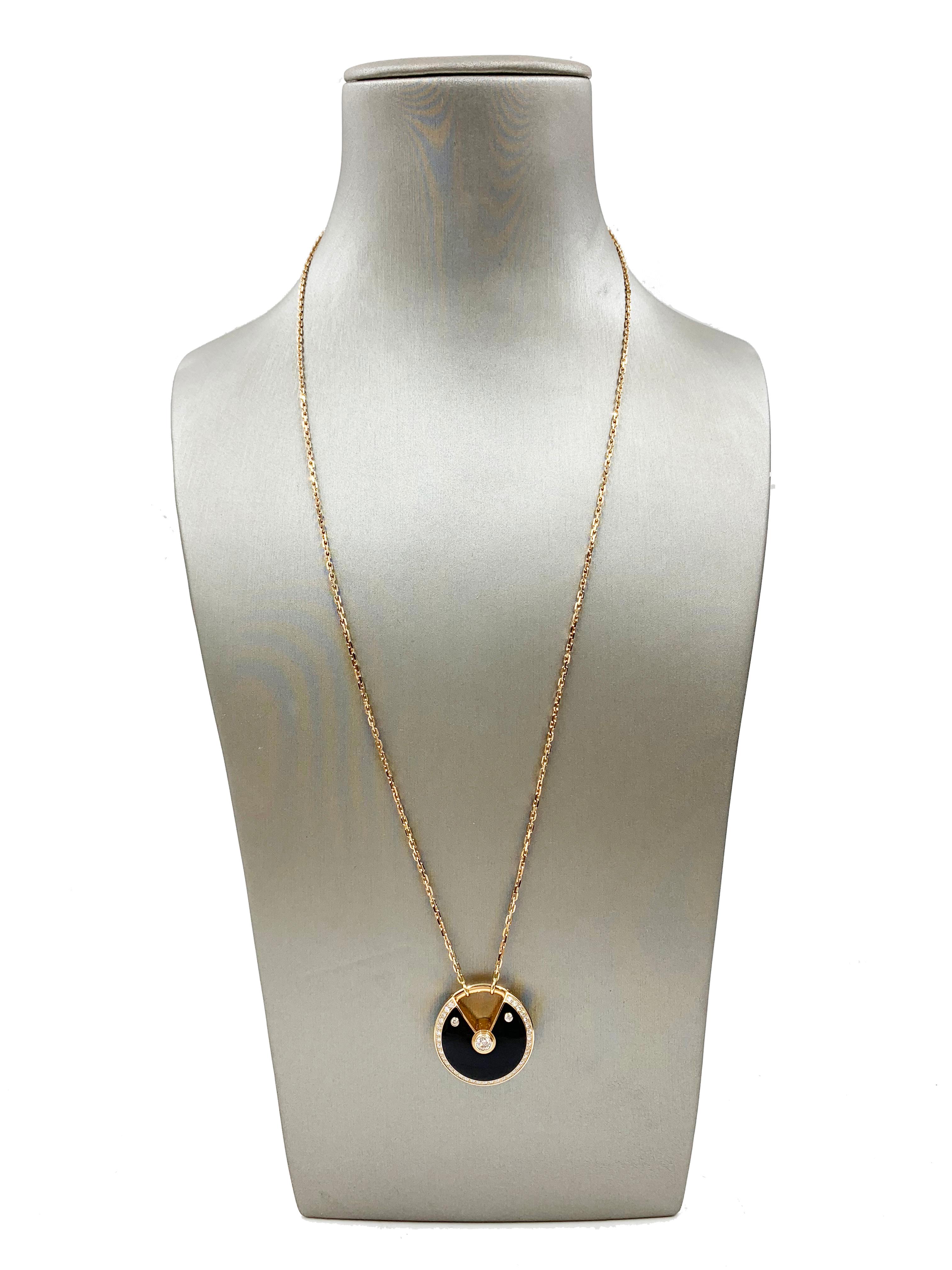 A beautiful Amulette De Necklace from Cartier made in 18K Rose Gold, Medium Model, set with 39 brilliant-cut diamonds, total weight 0.58 carats, onyx. Diameter of motif: 25 mm. Chain: 60 cm. REF: N3109800

Weight: approximately 27.2g
This item comes