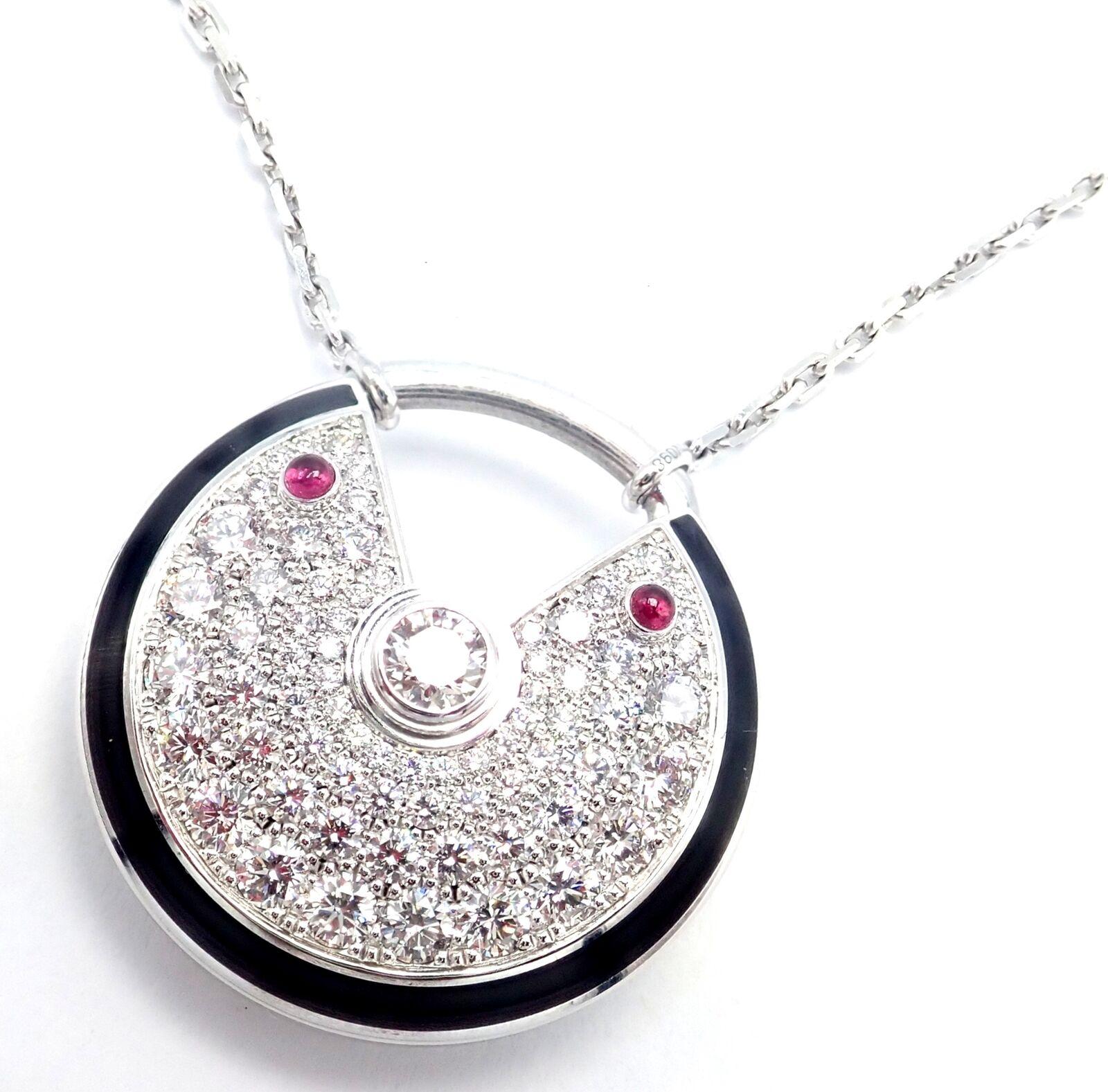 18k White Gold Diamond Ruby Large Amulette Pendant Necklace by Cartier.
With 70 Round Brilliant Cut Diamonds VVS1clarity, E color total weight approximately 1.40ct
2 rubies total weight approximately .15ct
This necklace is in mint condition and