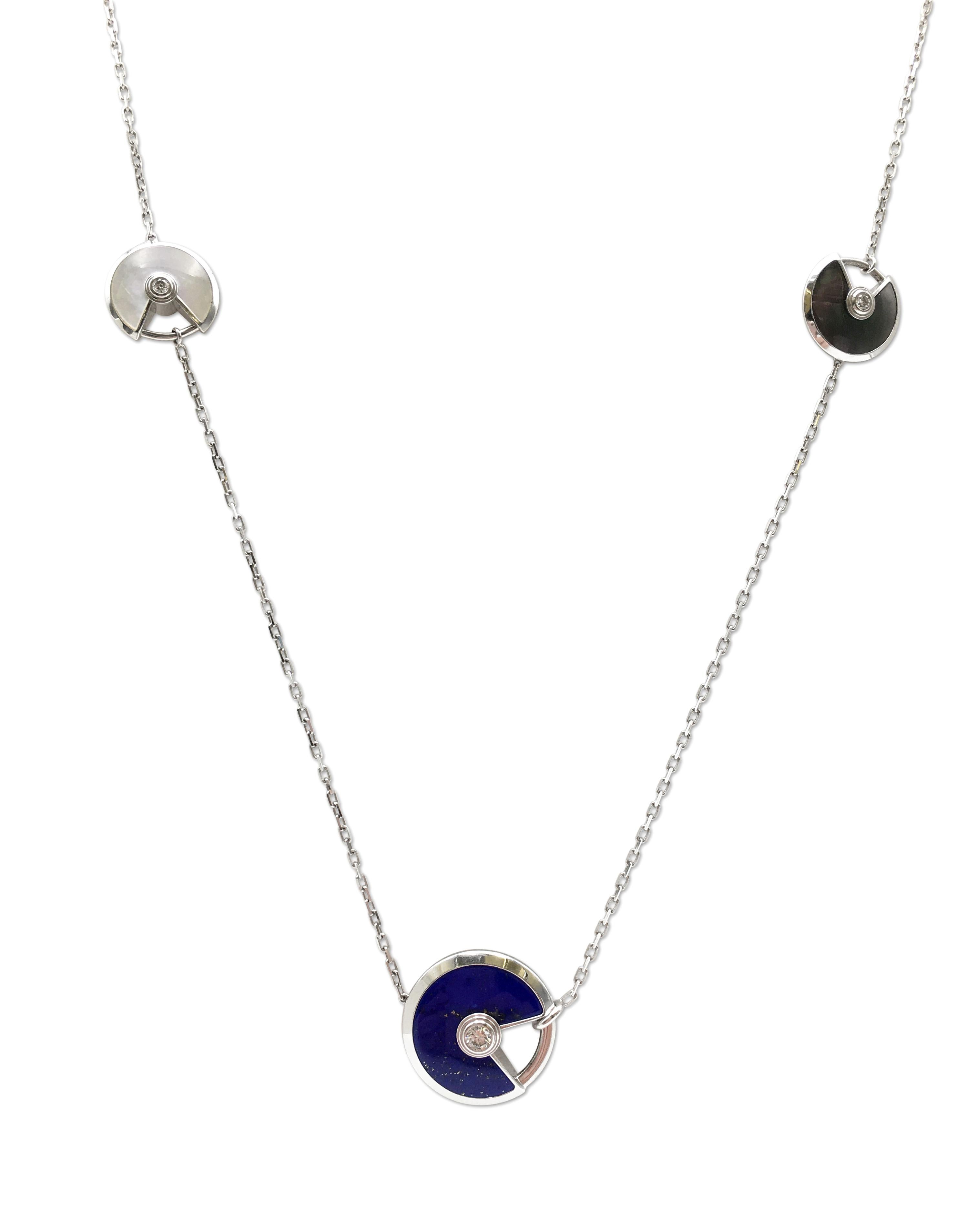 An authentic enchanting Cartier sautoir necklace from the 'Amulette de Cartier' collection. Set with colorful lucky pieces of lapis and mother-of-pearl discs set in 18 karat white gold. Of two various sizes, each disc is set with one high-quality