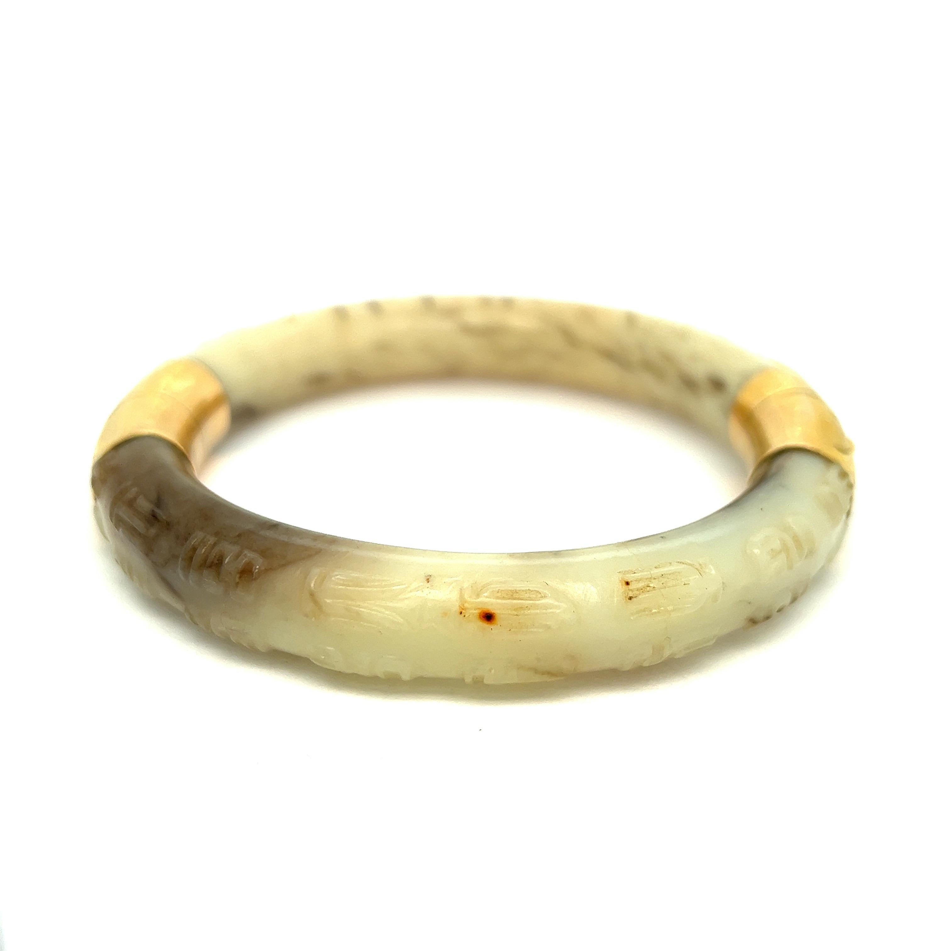 Cartier antique gold jade bangle bracelet, circa 1930s

18 karat yellow gold, white and black jade; marked Cartier, 18k, 750, 56048

Size: inner diameter 2.5 inches, inner circumference 8 inches
Total weight: 67.2 grams