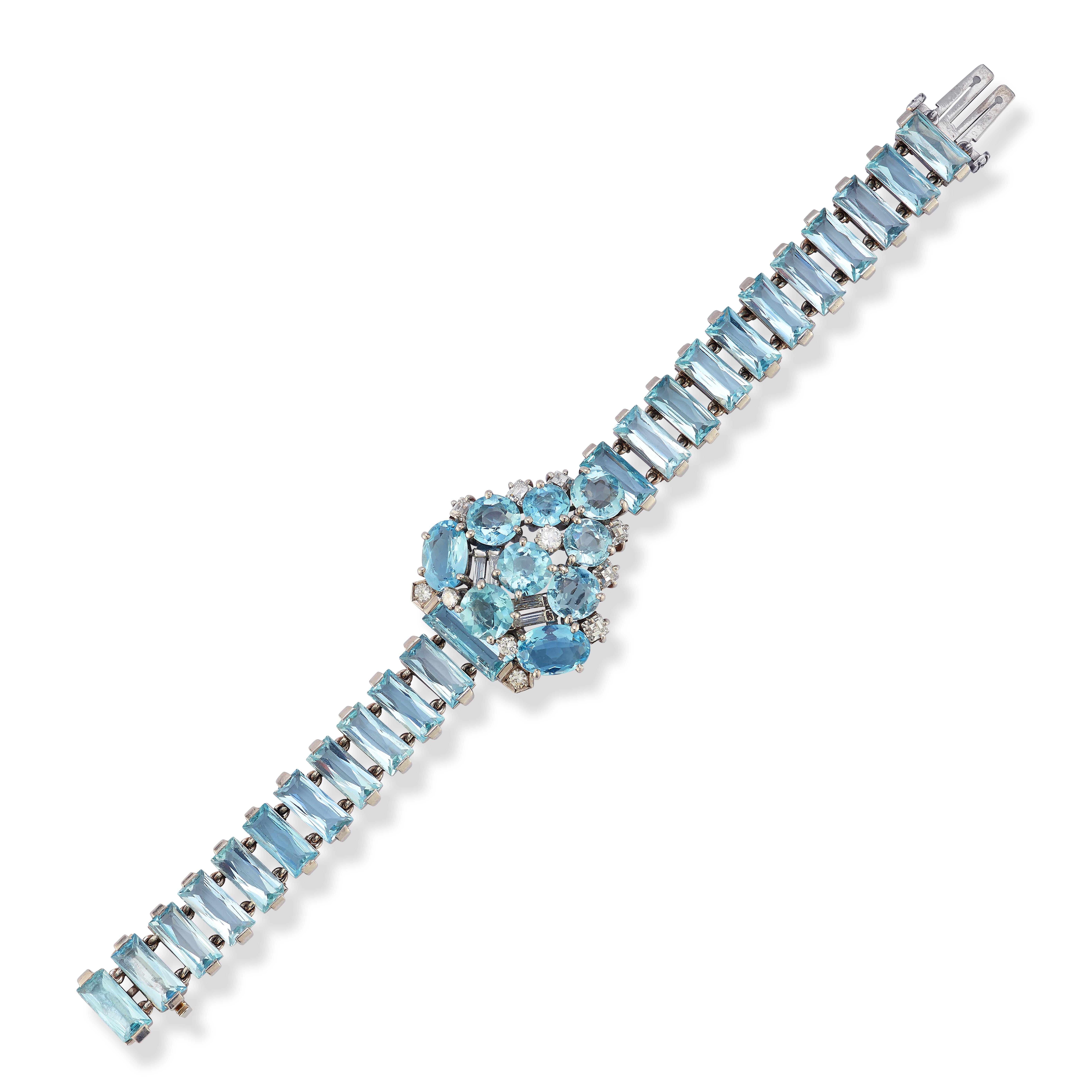 Cartier Aquamarine and Diamond Bracelet. Circa 1939

A bracelet with a central shield-shaped panel featuring one rectangular-cut, two oval, and seven round aquamarines, along with six square step-cut and 22 rectangular scissor-cut aquamarines,