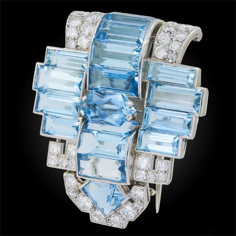 Platinum brooch, set with step and fancy-cut aquamarines and diamonds, signed Cartier.

Circa 1930s
Approx. 1 1/2″ long