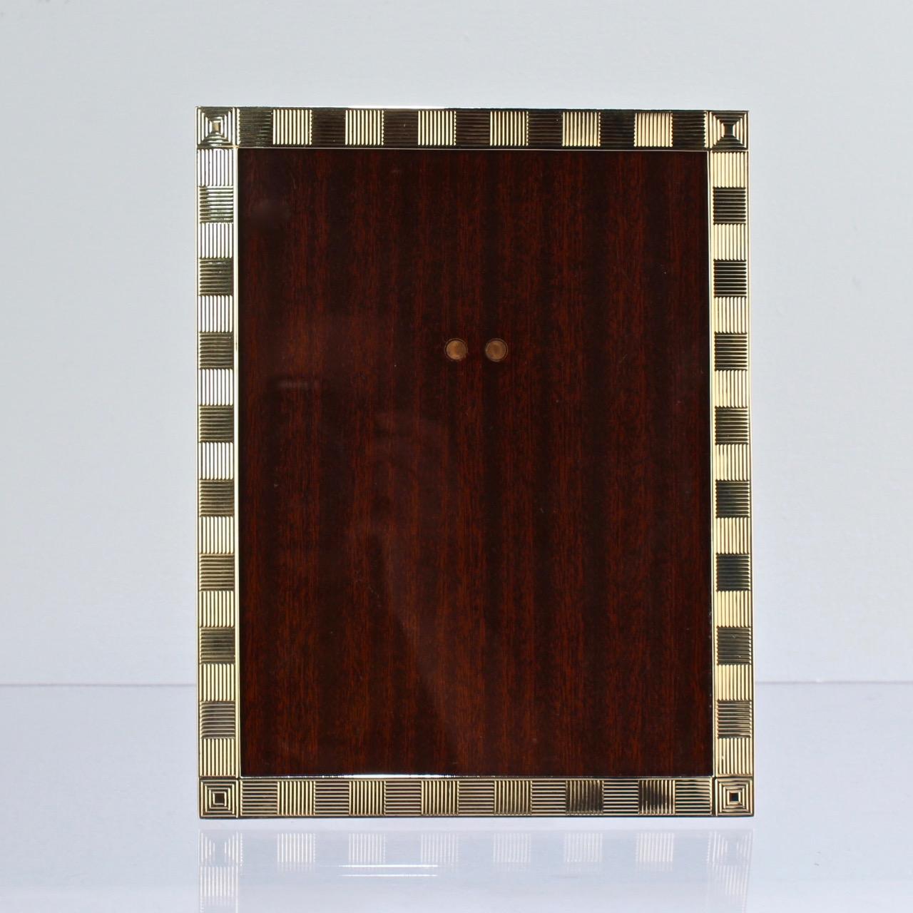 A superb Cartier 14k gold photo frame.

With an alternating, ribbed Art Deco pattern to the front.

A frame of simply the finest quality from one of the world's most important retailers! 

The base is marked for Cartier, 14K, and with a model