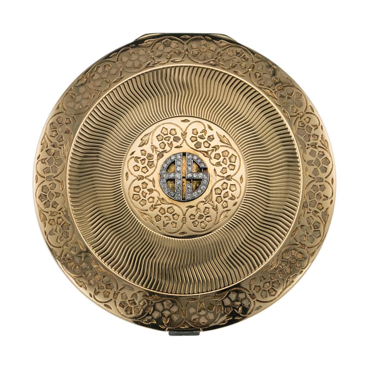 Antique 20th century Cartier Art Deco 18-carat gold compact, of circular form, set with diamond monogram and banquet cut diamonds push-button, both sides are inlaid with floral design champleve' creamy pink enamel and engraved sunburst motif to