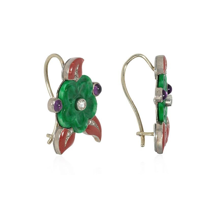 A pair of Art Deco jade, gemstone, and enamel earrings in the form of colorful flowers, the carved jade blooms set with diamond centers and embellished by cabochon amethysts and burgundy enamel leaves with diamond veins, in 18k white gold.  Cartier,