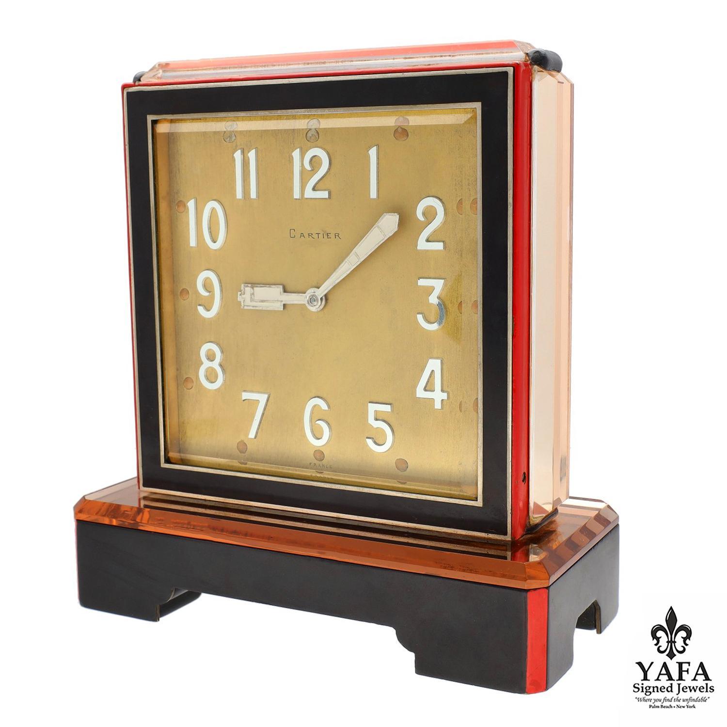 Double Dial with Engine-Turned Centerfield, Gold Dial Accented with Applied Silver Arabic Numerals.
Cathedral Hands, Square Case, Brass Bezels, Black Hardstone Boarding Red and Black Enamel, and Faceted Mirror.

Circa - 1920's with Cartier Fitted