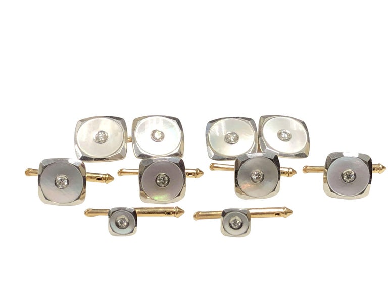 Circa 1940 Cartier Tuxedo Dress set, consisting of Cufflinks, 4 shirt Studs and 2 Collar or vest studs, 14K White Gold tops with Yellow Gold backs, Mother of Pearl and centrally set with a Diamond. Each is signed Cartier, has Cartier numbers and
