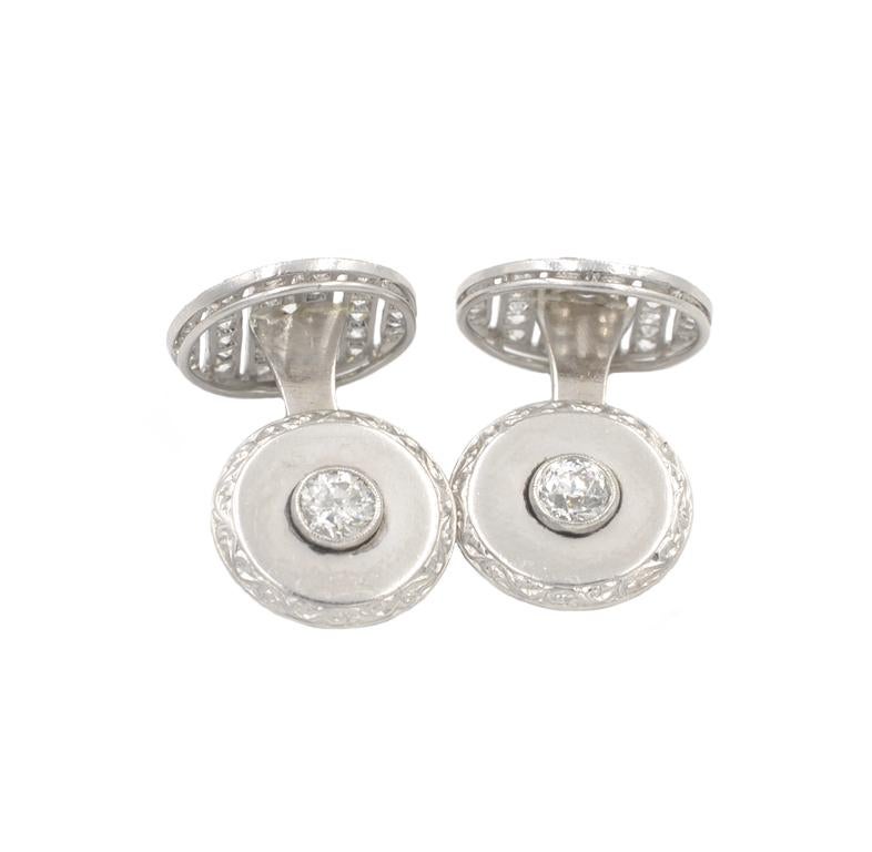 Cartier Art Deco platinum cufflinks from circa 1930.  These beautiful cufflinks feature 38 Old European Cut diamonds. One side of the cufflinks feature a bezel set diamond, approximately 0.40 carats each, with surrounded by a smooth platinum disc