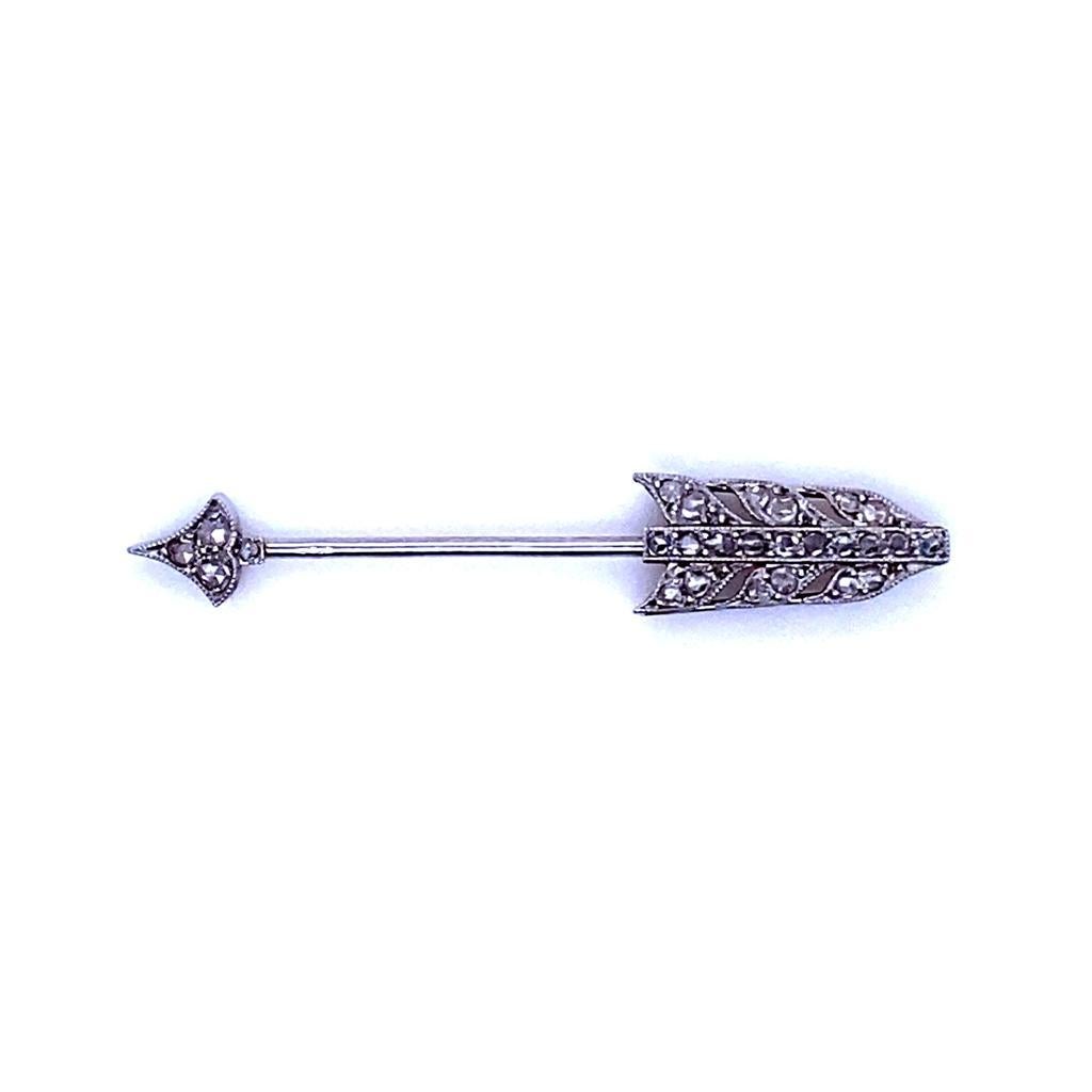 A Cartier Art Deco diamond jabot pin, circa 1925.

This sweet jabot pin embodies the glamour and the modish motifs of the Roaring 20s perfectly.

The fletching and arrow head are both grain set with rose cut diamonds of approximately 0.25 carats in