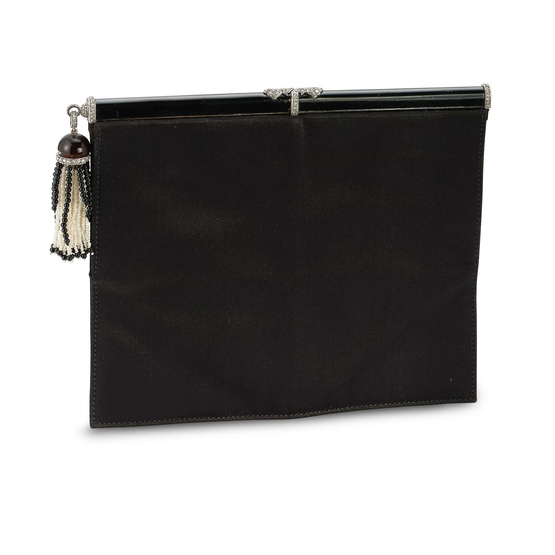 Cartier Art Deco Diamond Pearl Enamel & Onyx Clutch

Made Circa 1920 

Signed Cartier and Numbered

Measurements: 6
