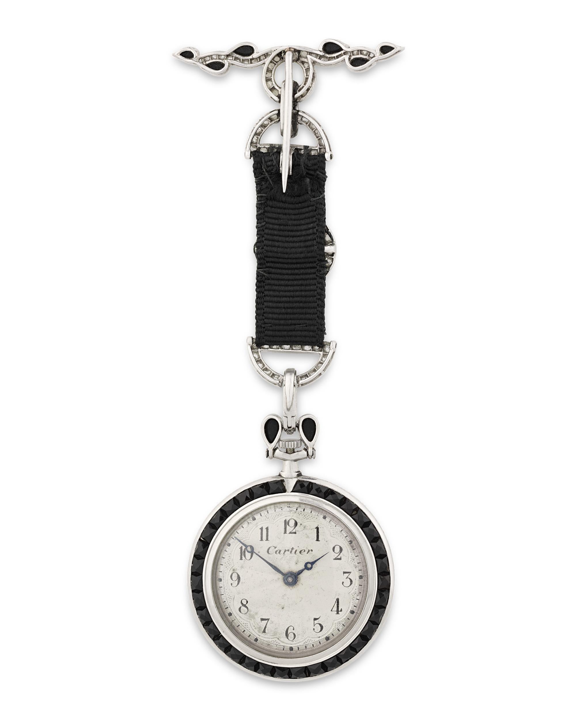 A study in bold design, this elegant pendant watch by Cartier is in a class of its own. Crafted of platinum with a jet bezel, the timepiece features pierced hands and painted Arabic numerals on the dial. Diamonds totaling approximately 0.50 carat