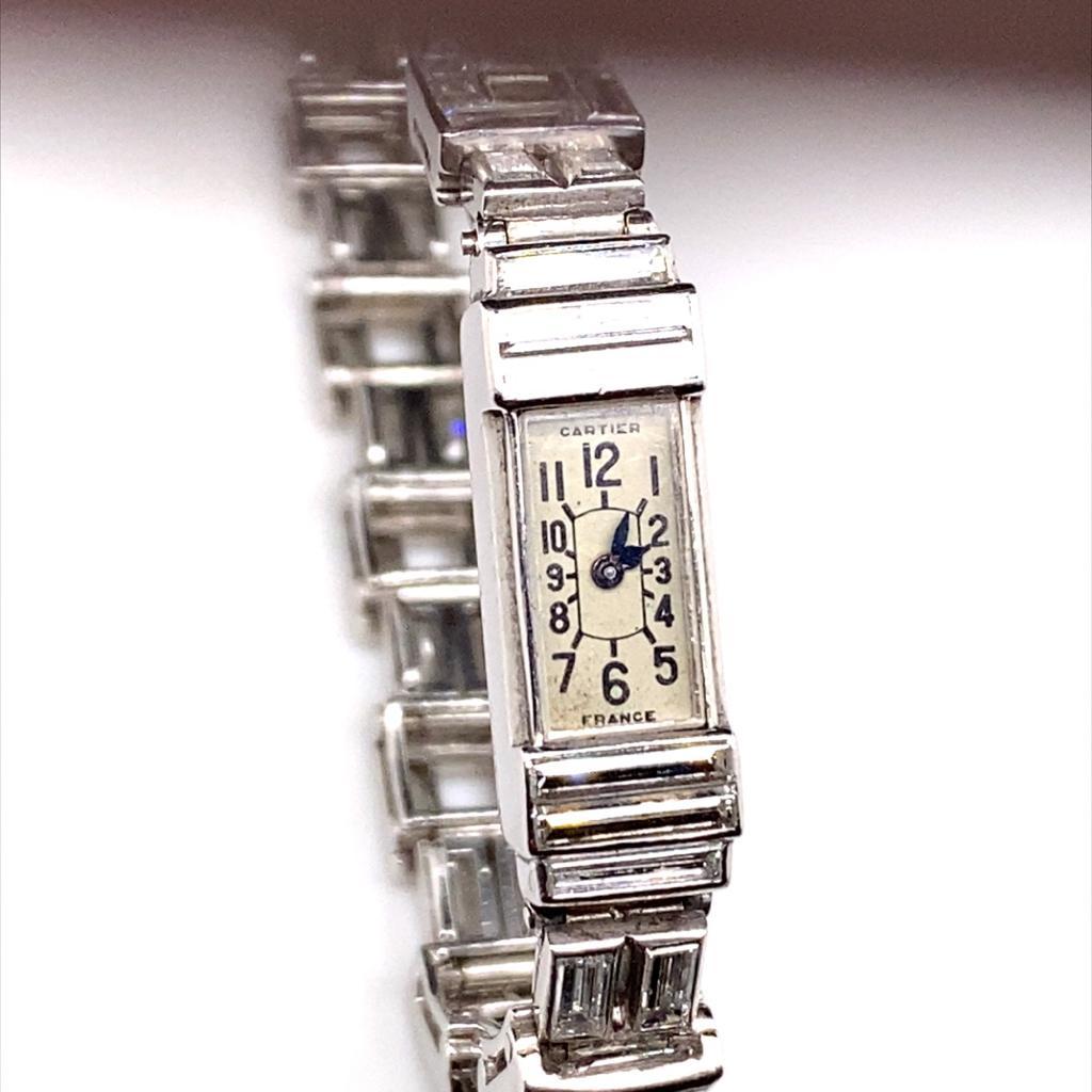 An exceptional and rare diamond set Art Deco platinum cocktail watch by Cartier.

Designed a series of elegantly articulated square and rectangular links. Comprising of eighty two baguette cut diamonds each within its own polished platinum bezel