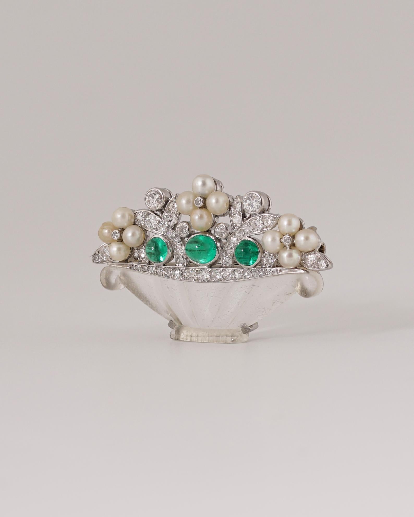 Express Shipping still available during Lockdown

Cartier
Flower Basket Brooch, Circa 1925.
Three Cabochon Emeralds (0,40 carat), Natural Pearls (3mm each), 47 single old European and round-cut diamonds (0,55 carats, H-J color and VS clarity),