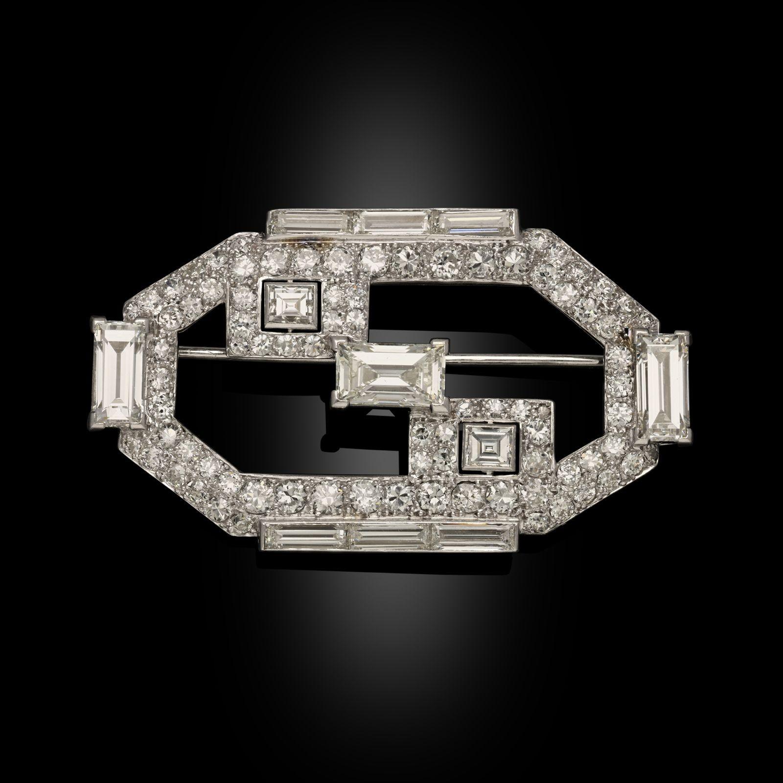 An Art Deco old cut diamond and platinum brooch by Cartier, circa 1930. This brooch is of a geometric design, set with a mixture of baguette cut and old European cut diamonds. The brooch is all set in platinum with a single pin fitting on the