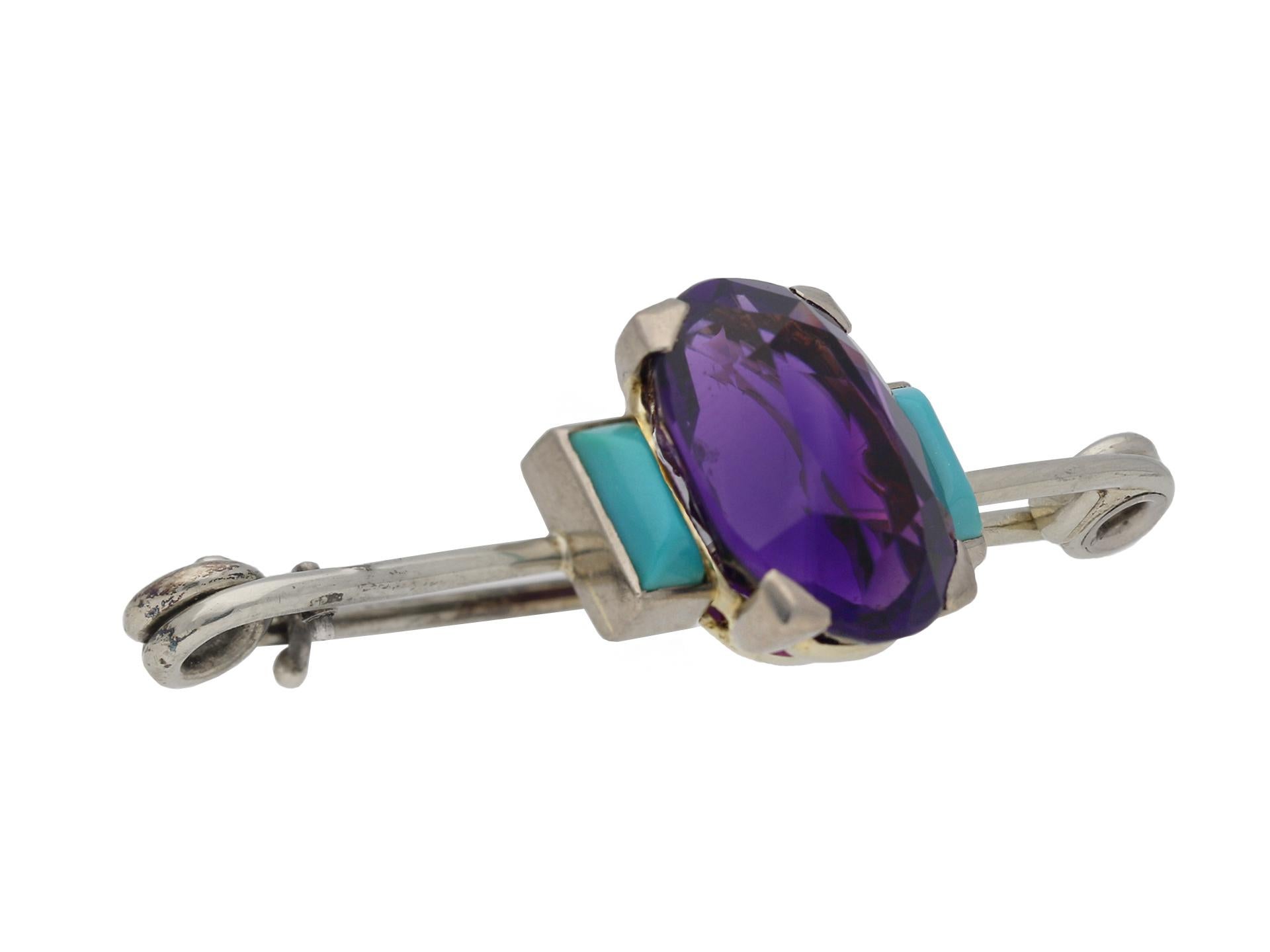 Art deco amethyst and reconstituted turquoise brooch by Cartier. Set to centre with an oval old cut natural amethyst in an open back structured claw setting with an approximate weight of 5.00 carats, flanked by two rectangular cabochon reconstituted