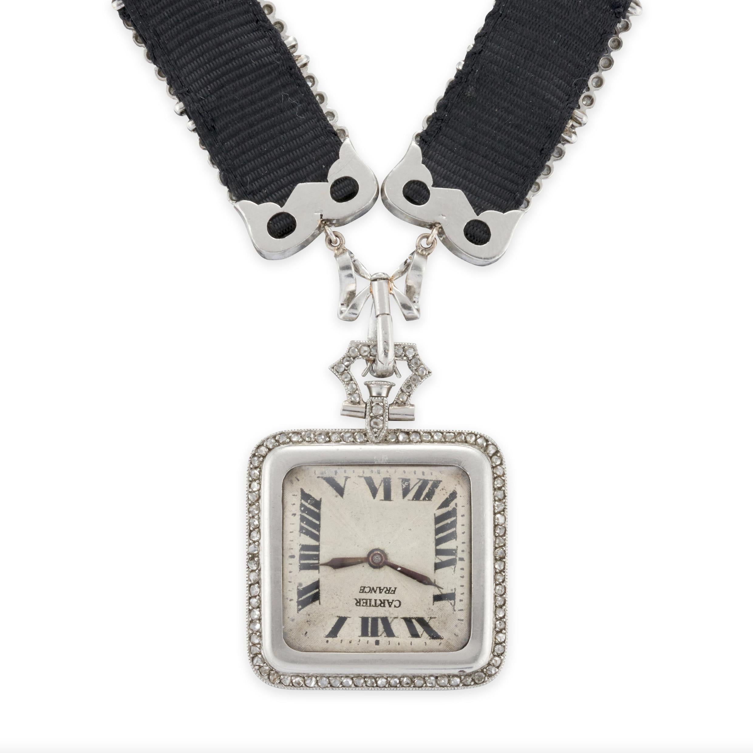 Cartier Art Deco Platinum and Diamond Pendant Watch

Details:
The square platinum case measuring 23mm, with rose-cut diamond border and applied design.
Movement: manual-wind 
Dial: Enamel, with Roman numeral indicators
The pendant watch joined to an