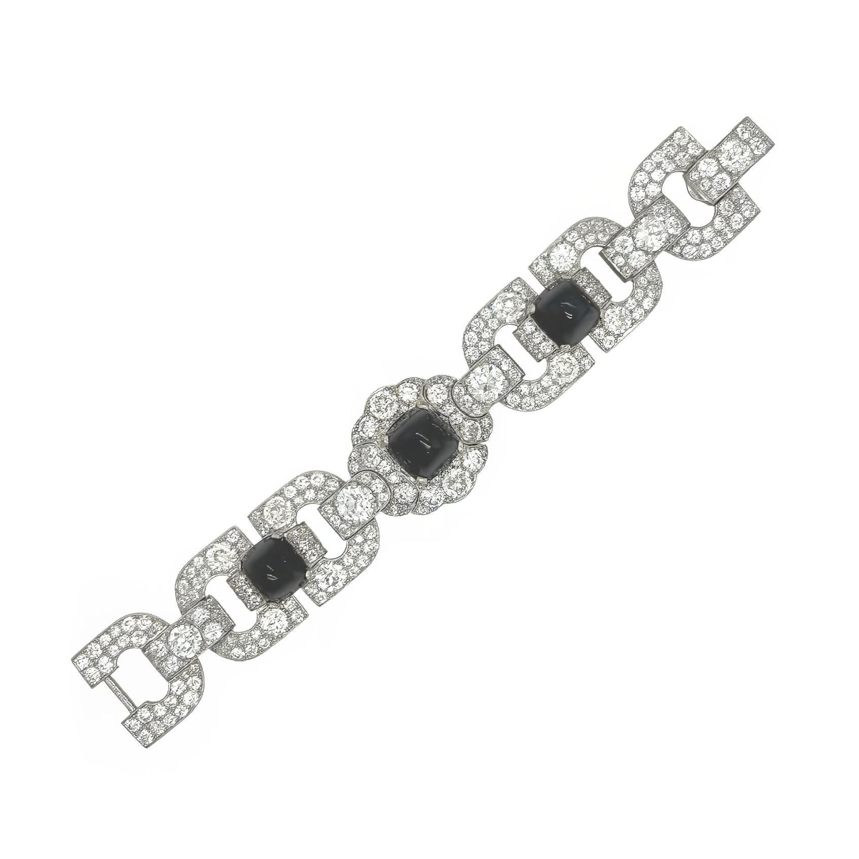 An Art Deco, platinum, sapphire and diamond bracelet.  Cartier.  Set with three sugarloaf cabochon sapphires totaling approximately 45 carats, five old European cut diamonds totaling approximately 6.5 carats and two hundred and fifty-eight old