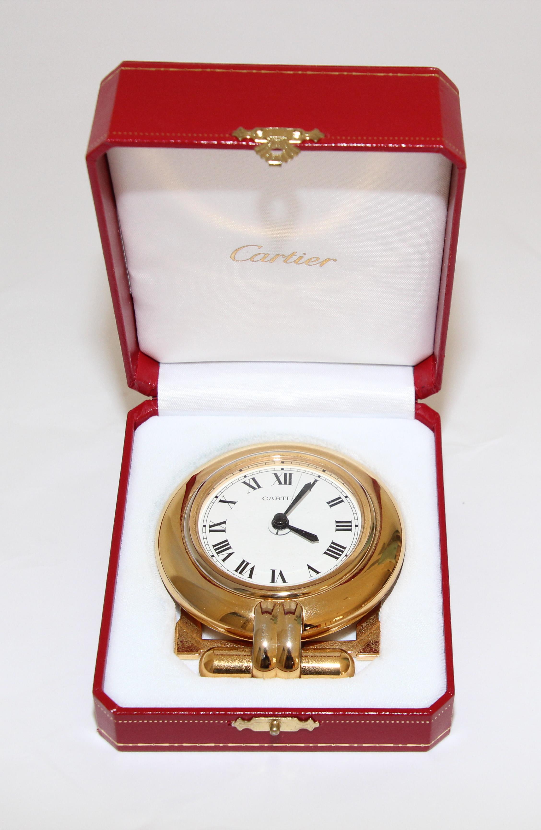 Vintage Cartier 24-karat gold-plated Art Deco travel quartz desk clock with alarm.
Cartier 24-karat gold-plated and lapis lazuli quartz travel or desk accessory clock is no longer being made.
It is vintage from the 1990s. It was originally