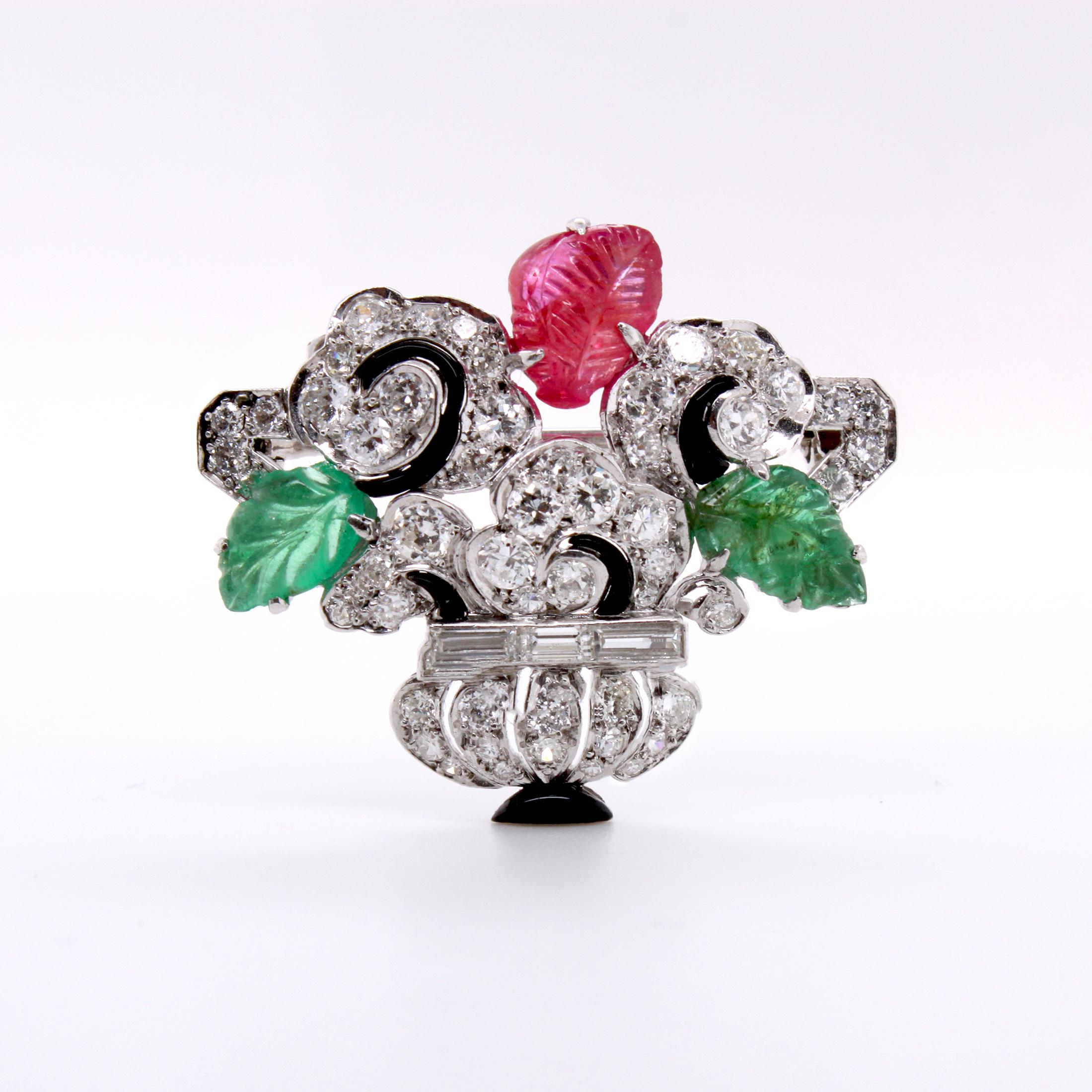 Cartier Art Deco Tutti Frutti Flower Vase Brooch, ca. 1930s

A beautiful and rare Cartier Tutti Frutti brooch depicting a flower vase with carved ruby and carved emerald leaves. The rest of the brooch has round brilliant cut and step cut diamonds,