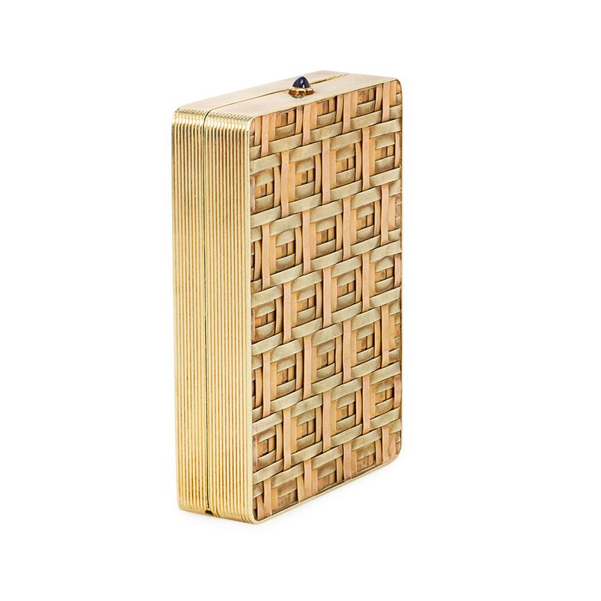 An Art Deco green and rose gold mirrored compact / pill box of basket-weave design with a cabochon sapphire closure, in 14k.  Cartier, New York #583.  Approximately 2