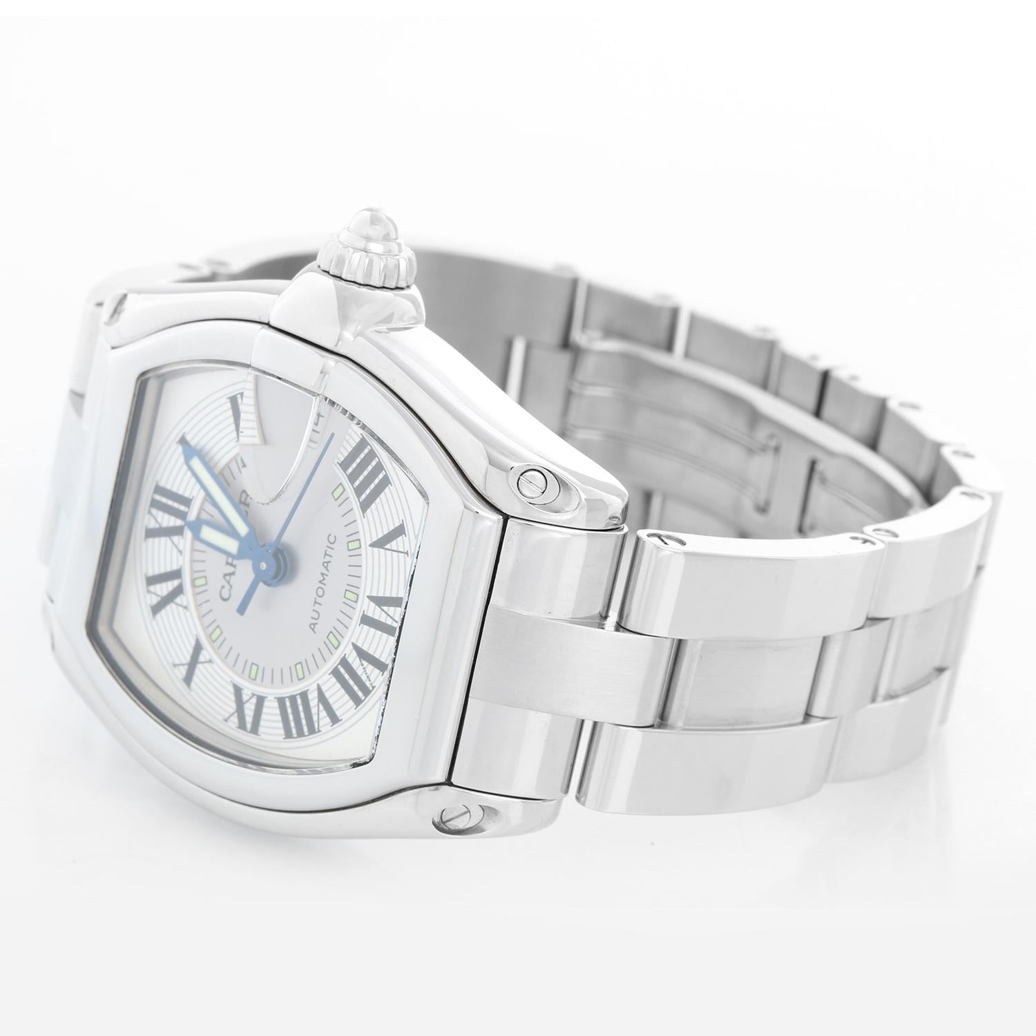 Cartier Automatic Stainless Steel Roadster  Men's Watch W62025V3 - Automatic. Stainless Steel Tonneau shaped case ( 37mm x 44mm). Silver dial with Roman numerals ; Date at 3 o'clock. Stainless Steel with double fold clasp. Pre-owned with custom box .
