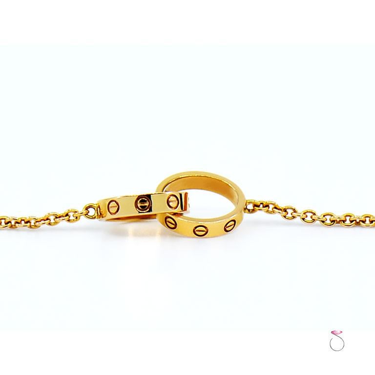 Cartier LOVE bracelet in 18k rose gold, also called Baby Love bracelet. Beautifully crafted and features two Love rings interlocked and attached to an oval link cable chain with a lobster clasp. This gorgeous Love bracelet is pre-owned in excellent