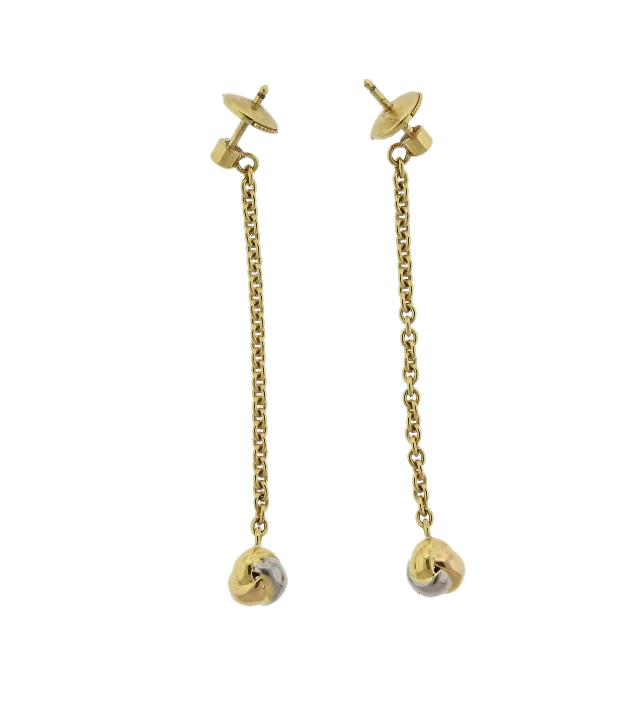 Pair of 18k gold long drop earrings by Cartier for Trinity collection. Come with COA and a copy of Cartier receipt from 2004 with $1300 retail. Current retail is significantly higher. Earrings are 55mm long , bottom parts - 7mm x 6.5mm, weight is