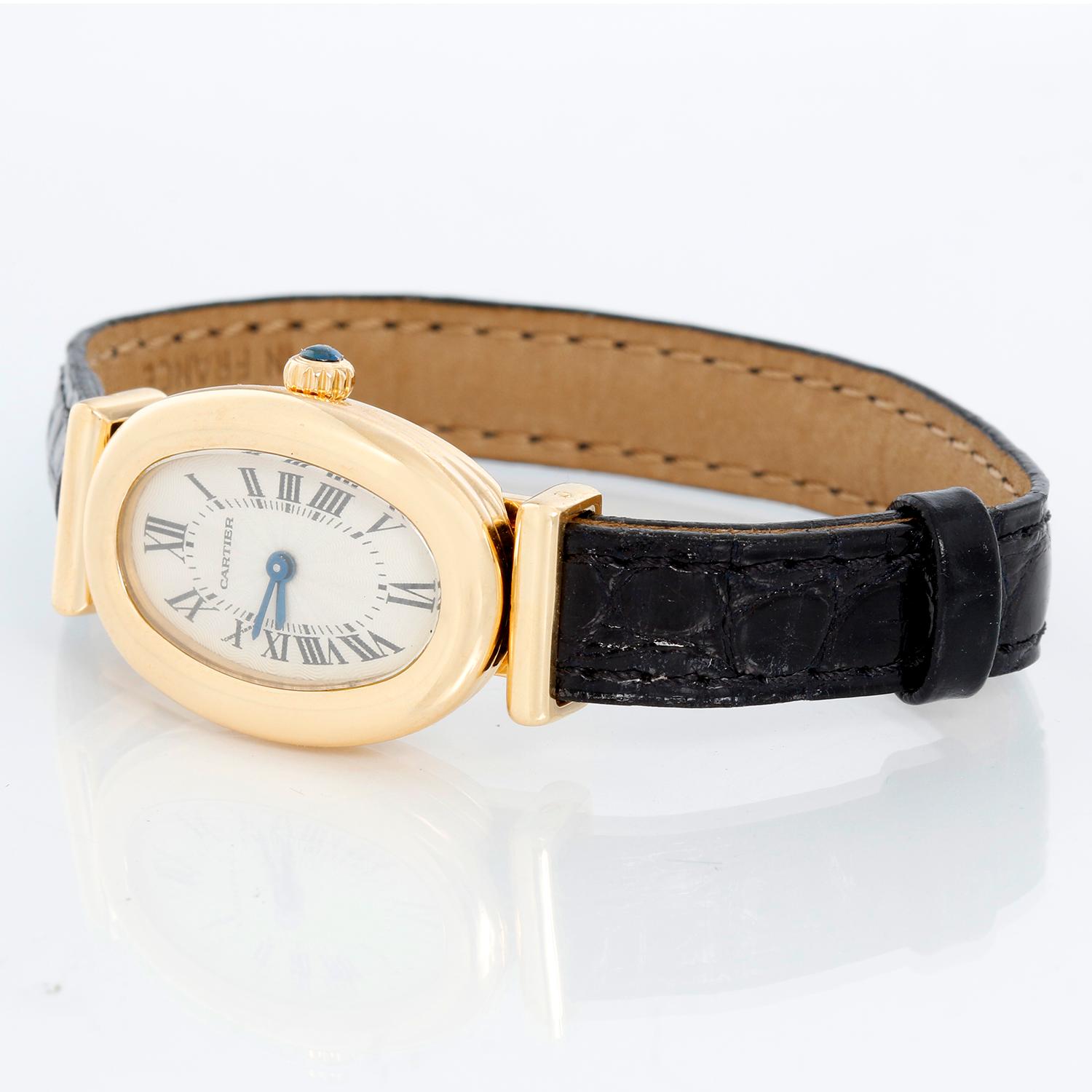 Cartier Baignoire 18K Yellow Gold Watch - Quartz winding. 18K Yellow gold ( 19 mm x 33 mm ). Ivory dial with Roman numerals. Black Cartier strap with 18K yellow deployant buckle. Pre-owned with Cariter box and papers.