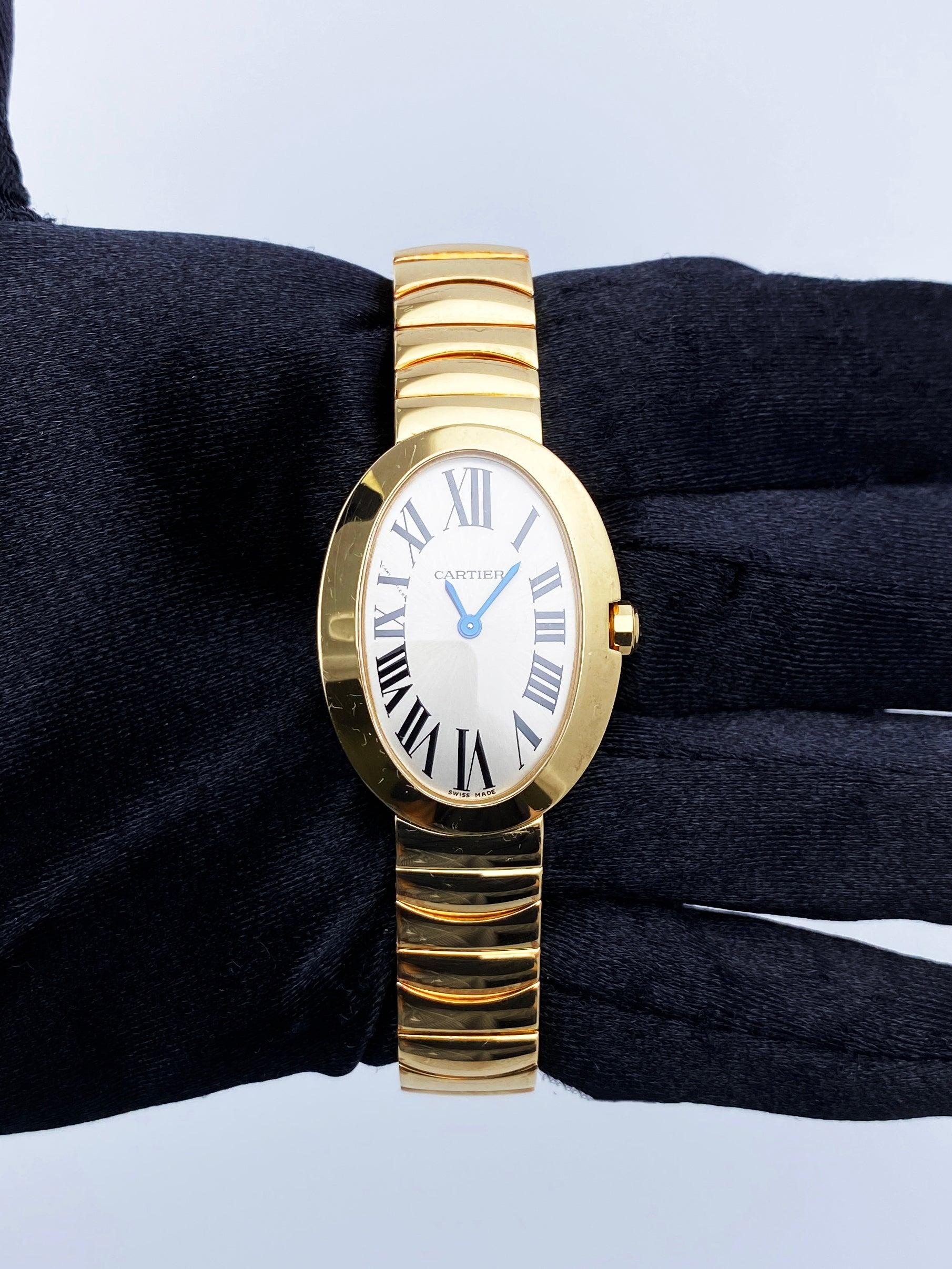 Cartier Baignoire 3208 Ladies Watch. 24.5mm 18K yellow gold case with 18K yellow gold bezel. Silver dial with blue hands and black Roman numeral hour markers. 18K yellow gold bracelet with hidden butterfly clasp. Will fit up to 6-inch wrist.