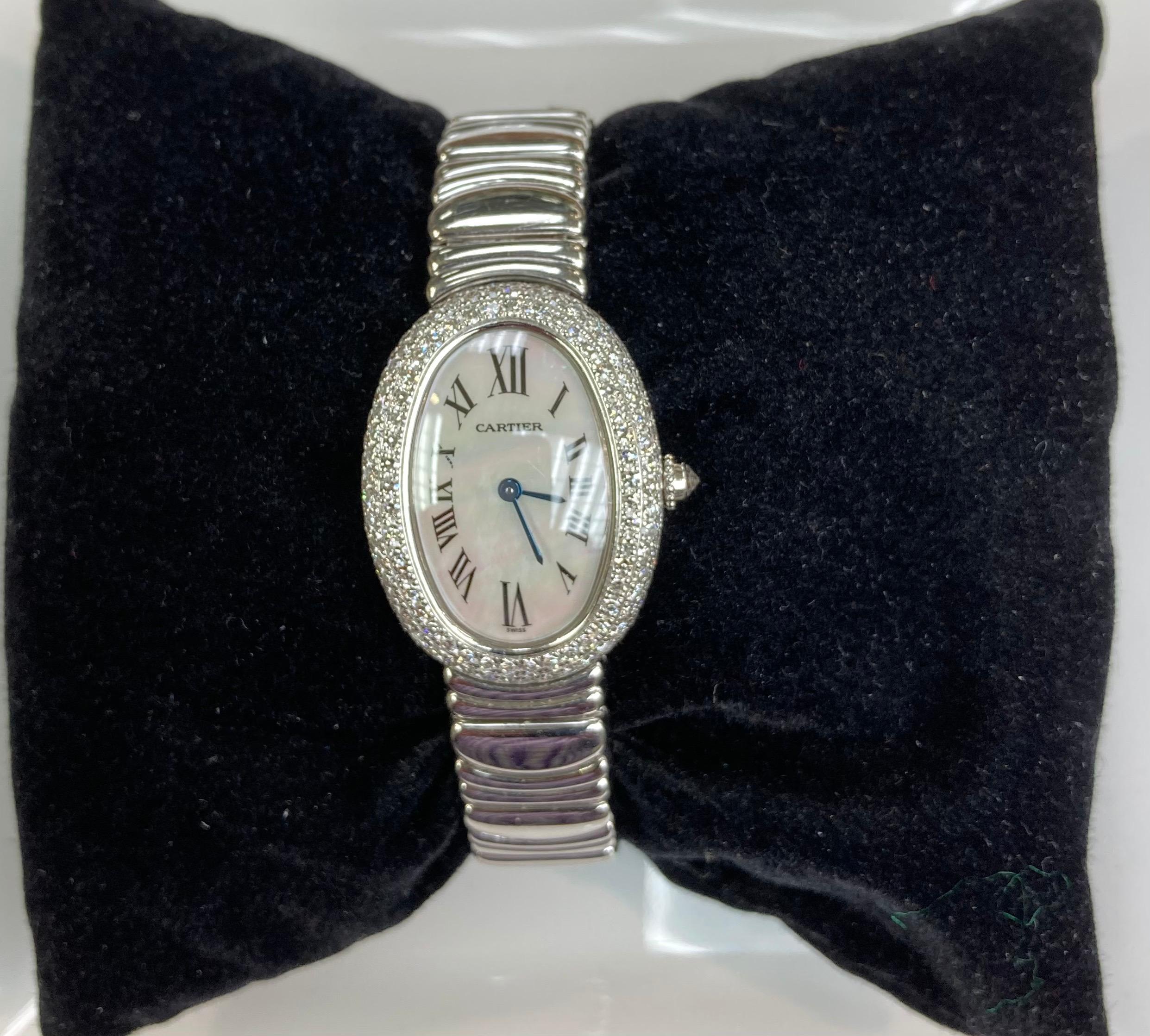 Cartier Baignoire diamond white gold wristwatch.  Ladies full size.  With three row diamond bezel.  Circa 2000

DIAL:  Mother of Pearl 

GOLD:  18k white gold

WEIGHT:  85.6 grams 

CASE:  31mm long by 22.5mm wide