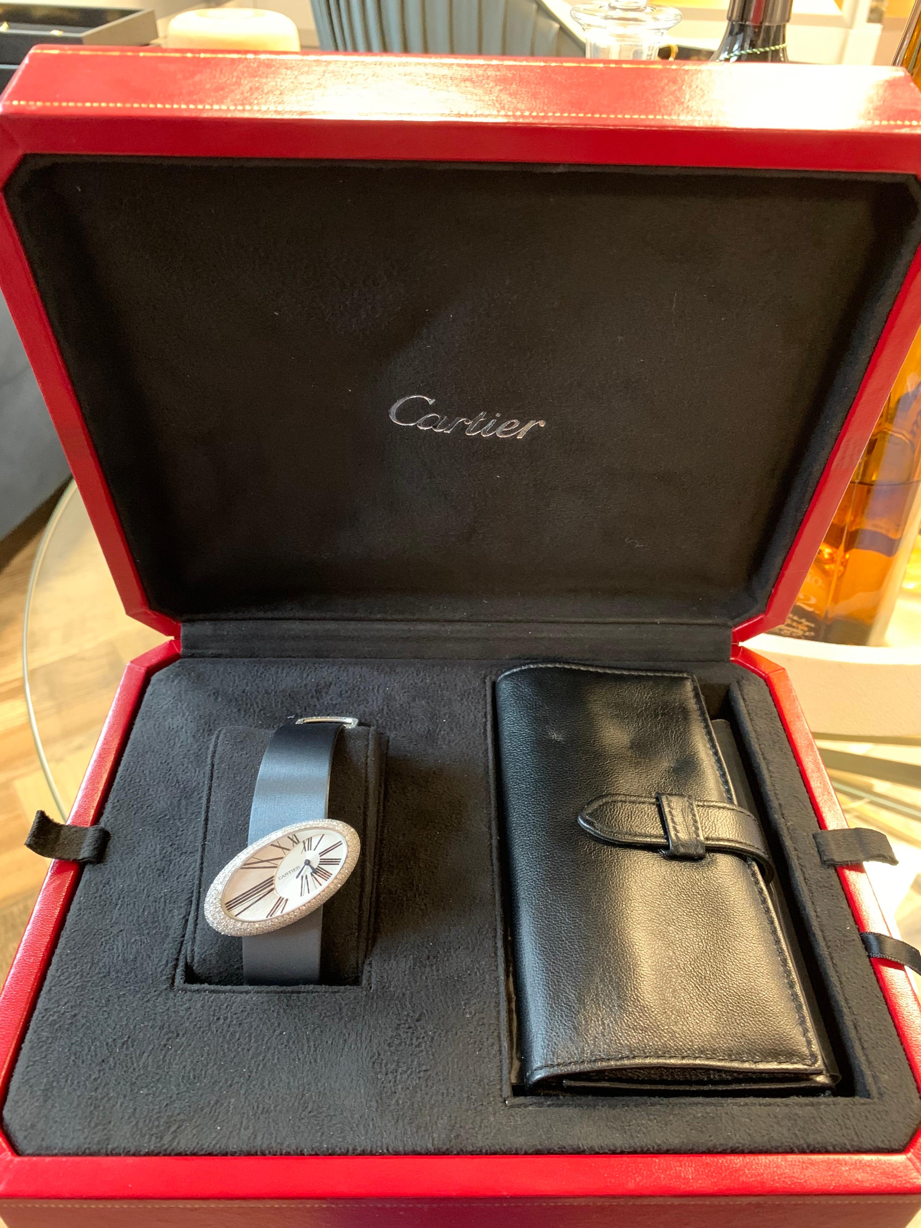 Rare Cartier women’s watch. This very rare watch from the legendary house of Cartier features elongated oval case in 18k white gold bezel set with round brilliant cut E-F color VS clarity Diamonds. 
This collectors item can be worn as a piece of