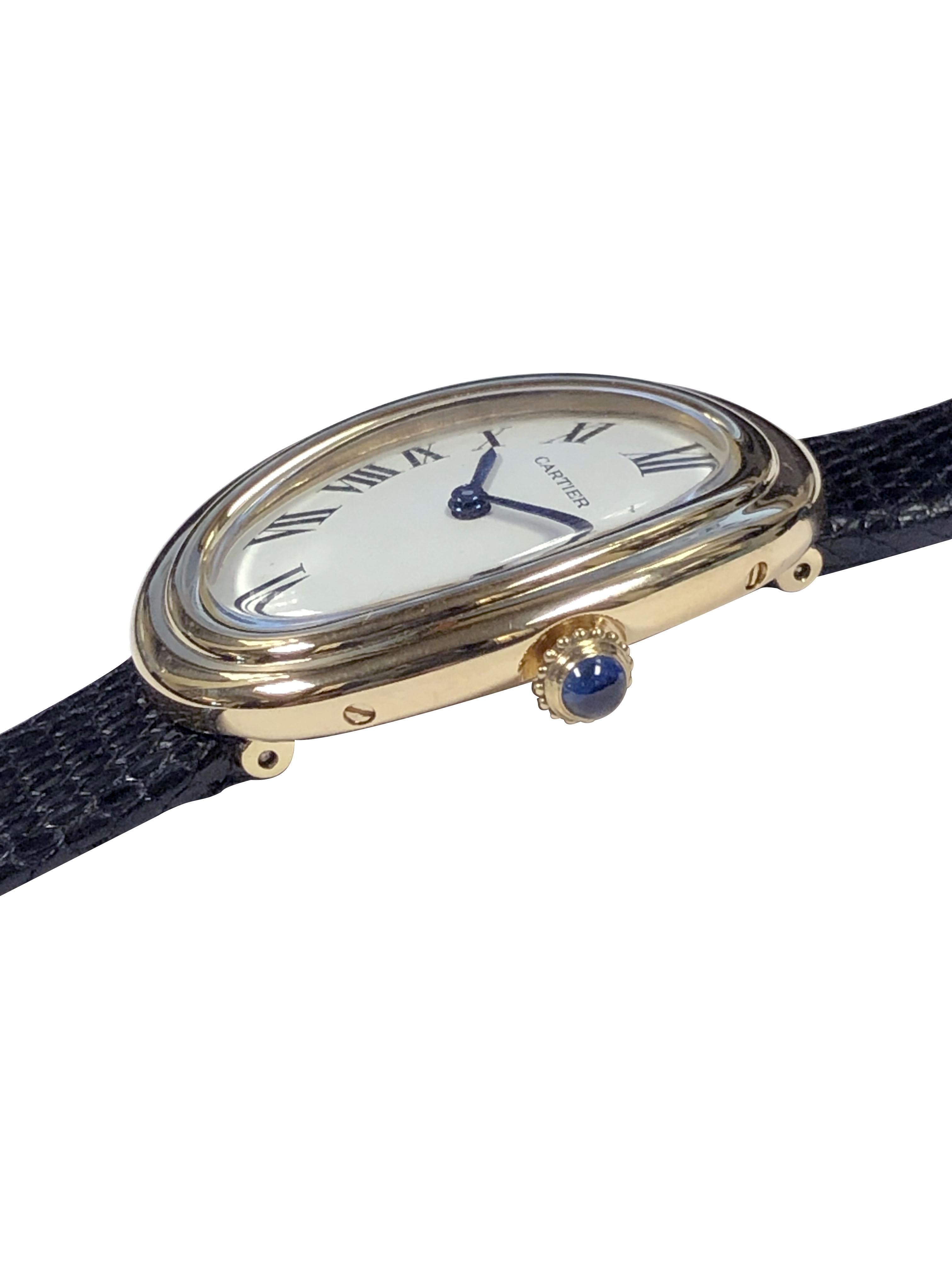 Circa 1980s Cartier Baignoire collection Ladies Wrist Watch, 30 X 23 M.M. 18k Yellow Gold 2 piece case, 17 Jewel Mechanical, Manual wind movement, white dial with Black Roman numerals, sapphire set Crown. New Hadley Roma Bracelet en lézard noir.