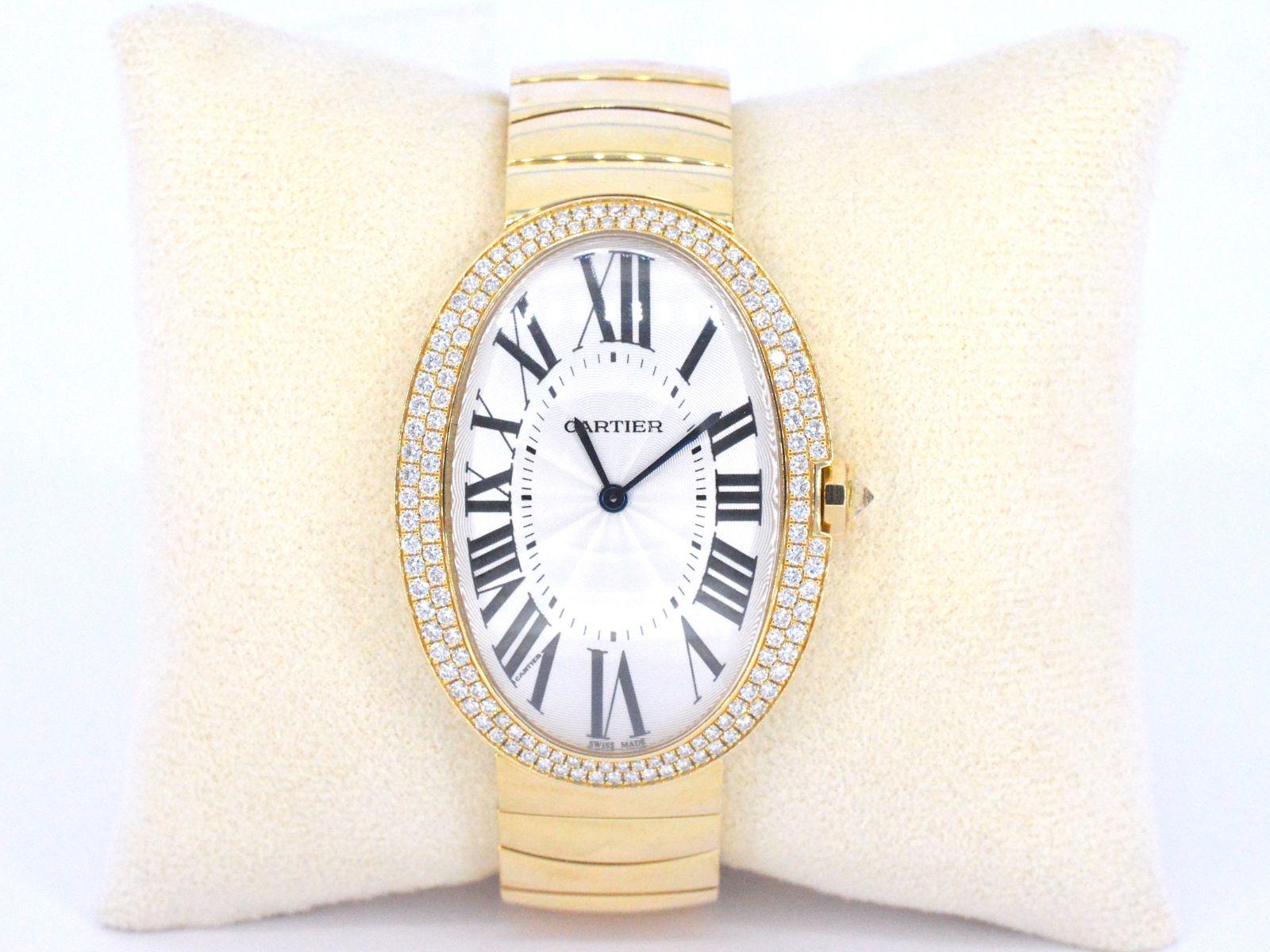 Cartier Baignoire Large 18k Gold Diamond Ladies Watch WB520003. Manual winding movement. 18k gold oval case 44 mm x 34 mm. Crown set with diamond. Original Cartier factory 149 diamond bezel. Scratch resistant sapphire crystal. Silver dial with black