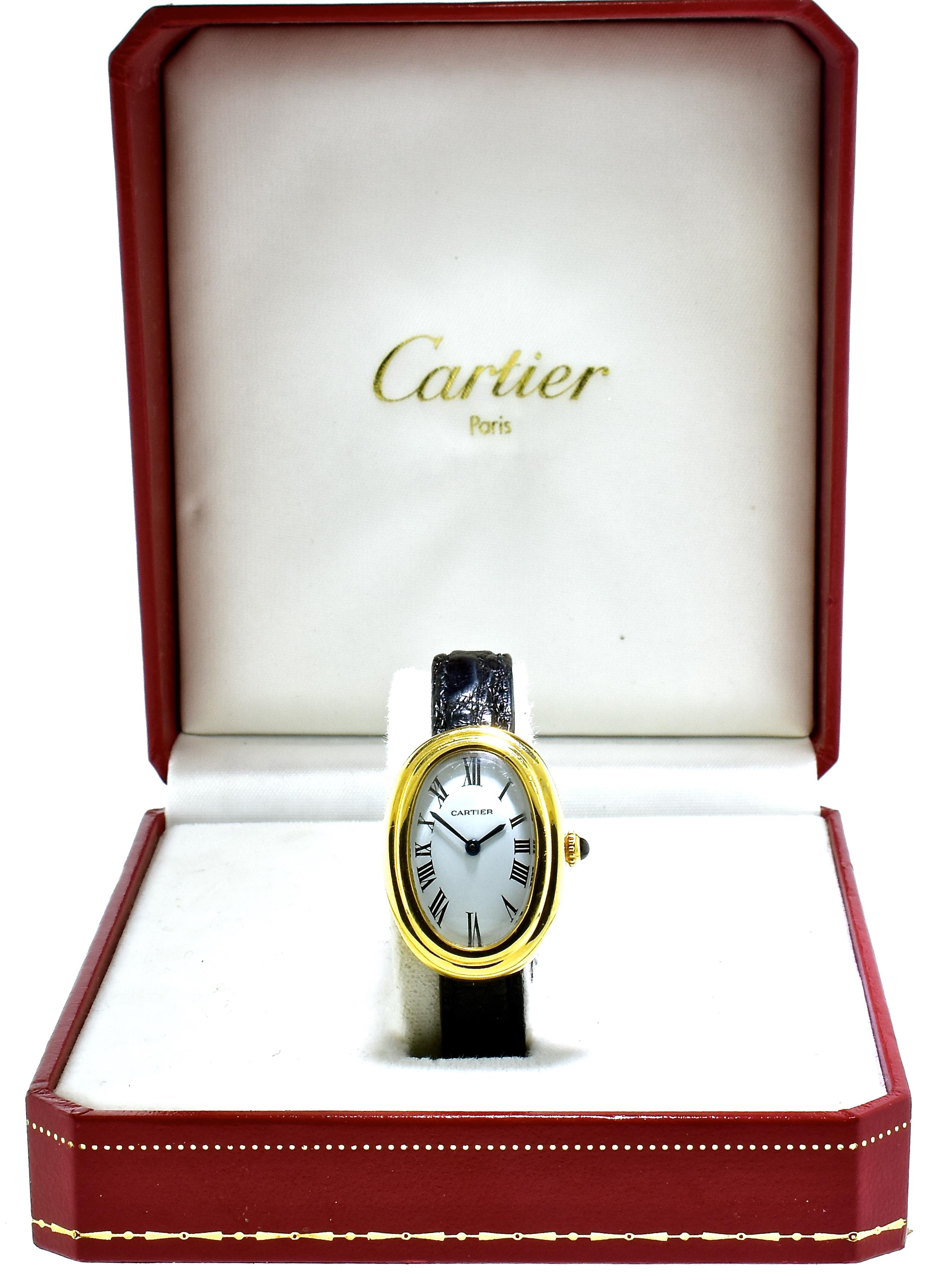 Cartier Baignoire 18K vintage 18K yellow gold wristwatch with reference no. 780941795,. the dimensions are: 23x32mm, this fine watch is a manual wind movement, with a white dial and the black hands are Roman numerals.  The Cartier strap has slight