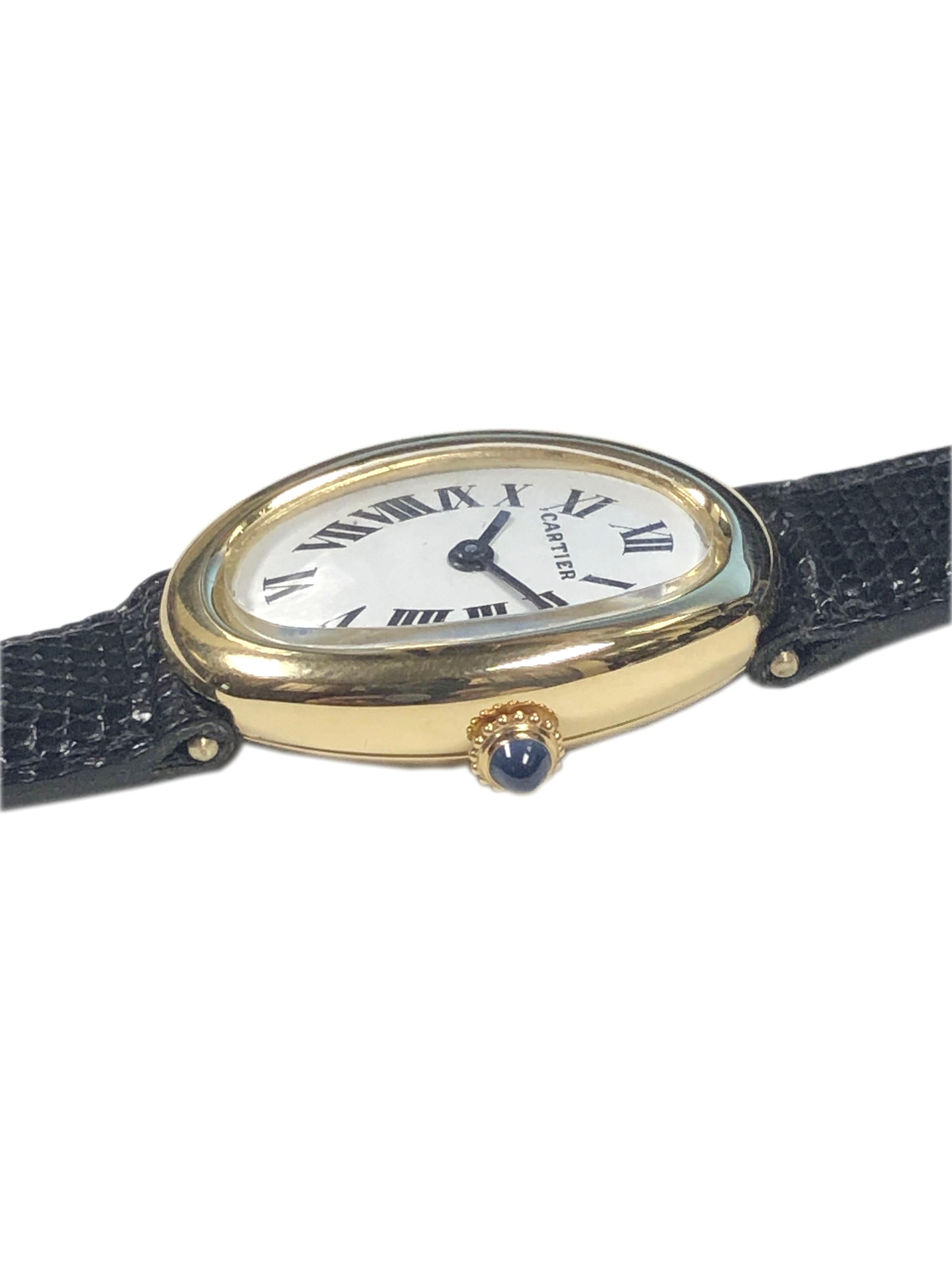 Circa 1970s Cartier Baignoire Ladies Wrist Watch, 30 X 22 M.M. 18K yellow Gold 2 piece case, 17 jewel Mechanical Manual wind movement, White dial with Black Roman numerals and a Sapphire Crown. Original Cartier Black Lizard strap with Cartier Gold