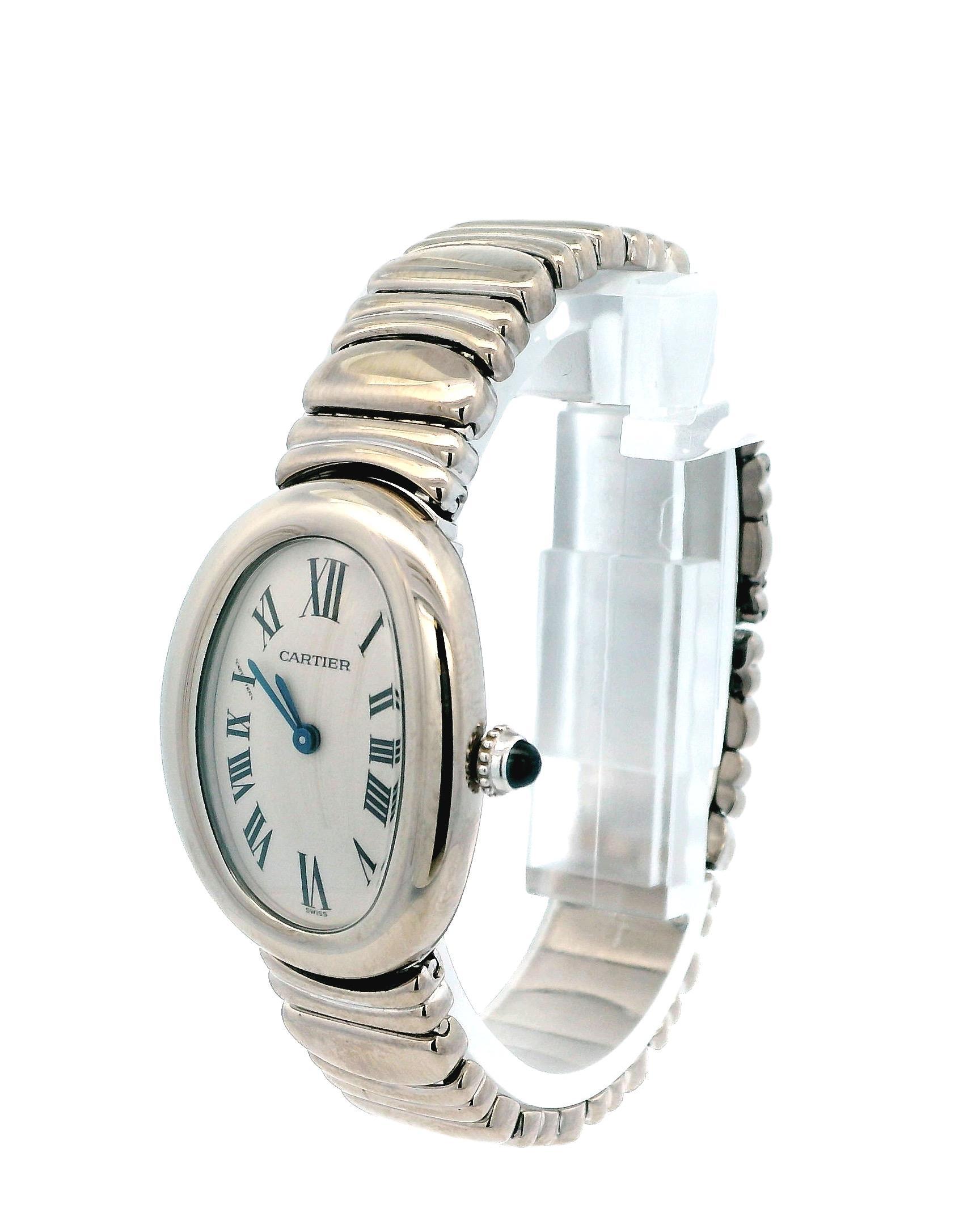 Cartier Baignoire 1955 Ladies Watch. 22mm by 30mm 18k white gold case non bezel. Ivory dial with blue hands and roman numeral hour markers. 18K white gold bracelet with hidden Butterfly Clasp fit to a 6.25-inch wrist. Sapphire Crystal, 18K white
