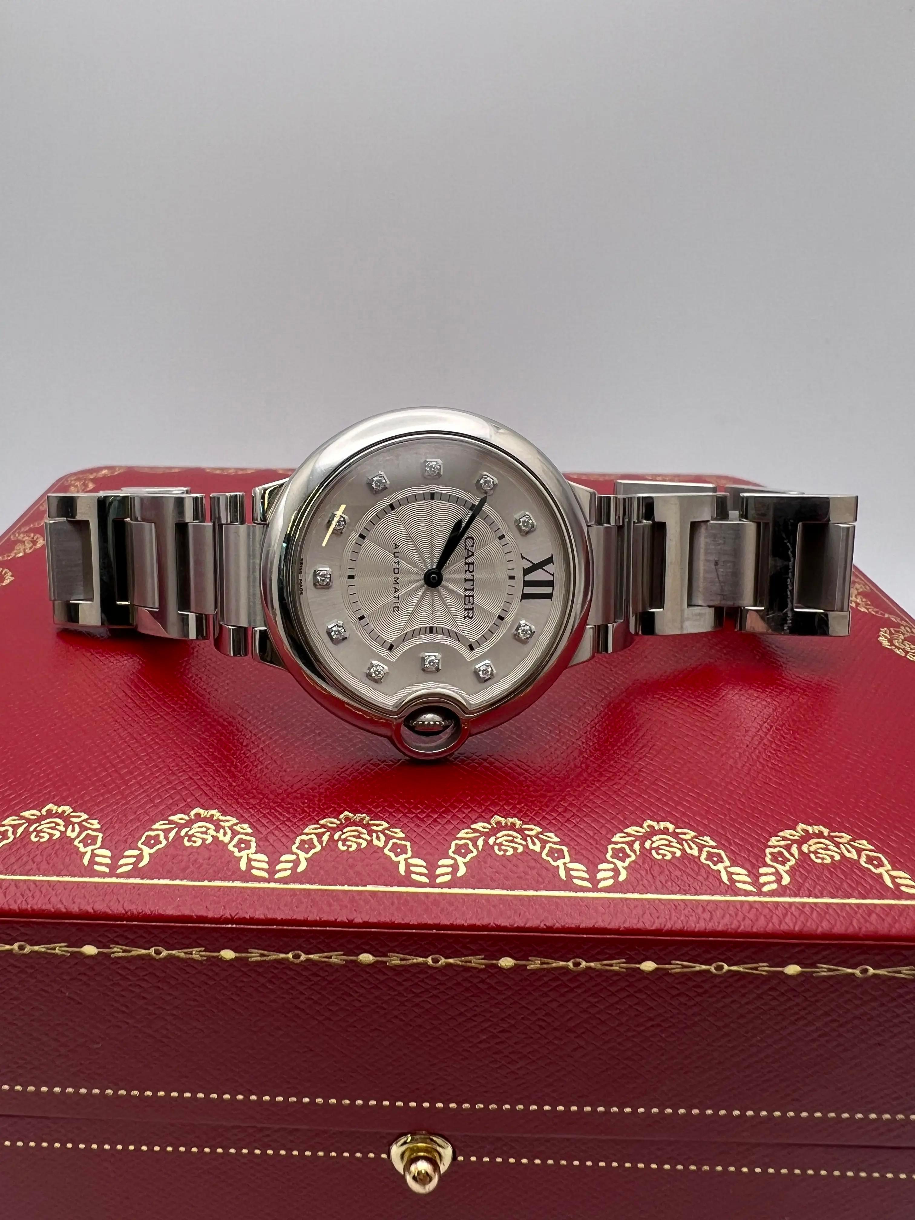 The Cartier Ballon Bleu 36mm (reference WE902075) is a refined timepiece that exemplifies Cartier's commitment to blending classic design with luxurious craftsmanship. Crafted from stainless steel, the 36mm round case is complemented by a matching