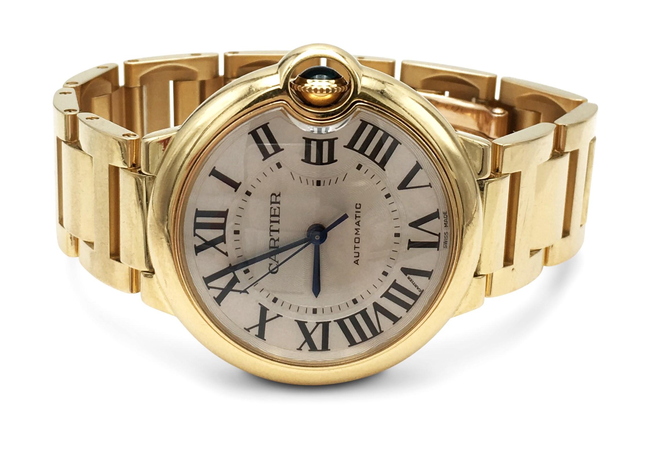 Authentic Cartier Ballon Bleu crafted in high polish 18 karat yellow gold. The round 36 mm case is finished with a domed crystal and a slightly domed gold case back. Silver sunray dial with painted black Roman numeral markers.  Hidden folding clasp.