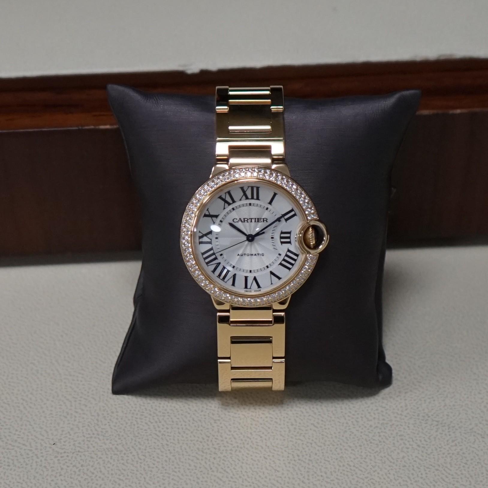 Pre- owned in very good condition Cartier Ballon Bleu 36mmx12mm yellow gold case, automatic self-winding mechanical movement, caliber Cartier 076, bezel set with 2 rows of brilliant cut diamonds  1.21cts total weigh, fluted crown set with sapphire
