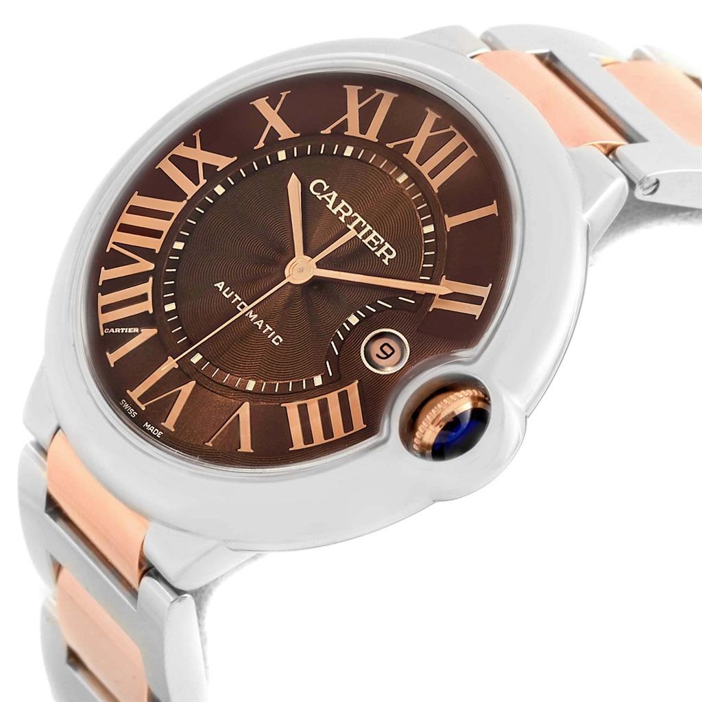 Cartier Ballon Bleu Steel Rose Gold Chocolate Dial Unisex Watch W6920032. Automatic self-winding movement. Caliber 049. Round stainless steel case 42 mm in diameter, 13 mm thick. Fluted 18k rose gold crown set with the blue spinel cabochon. Fixed