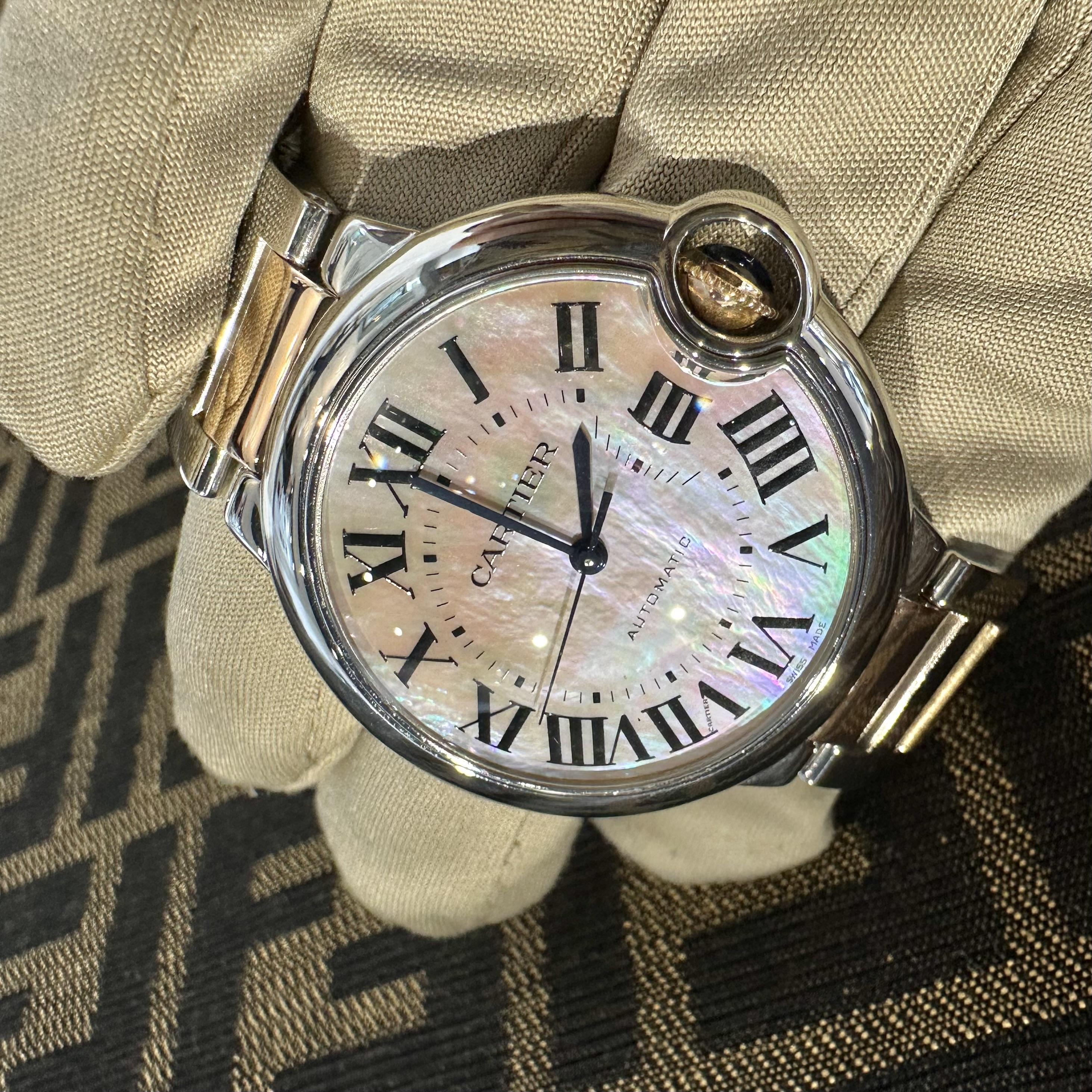 Brand: Cartier
Model Name: Ballon Bleu
Reference Number: W6920033
Movement: Automatic self-winding movement
Material: Stainless Steel / 18k Rose Gold
Dial: Mother of Pearl with Black Roman Numerals
Case Size: 36 mm
Case Shape: Round
Crystal: