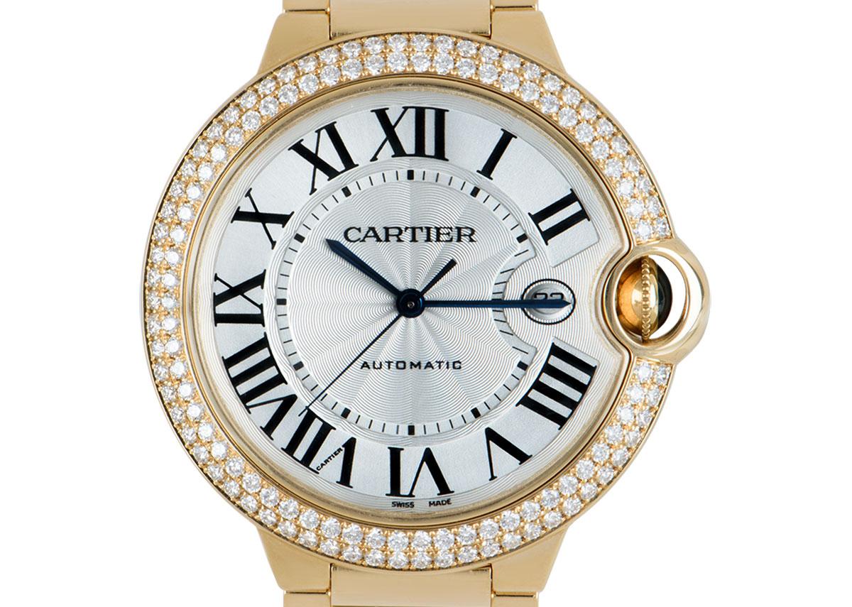 A 42mm Ballon Bleu in yellow gold by Cartier. Featuring a silver dial with a guilloche centre concealed by sapphire crystal, complimented by Roman numerals, sword-shaped hands in blued steel and a secret Cartier signature at V of VII. The guarded