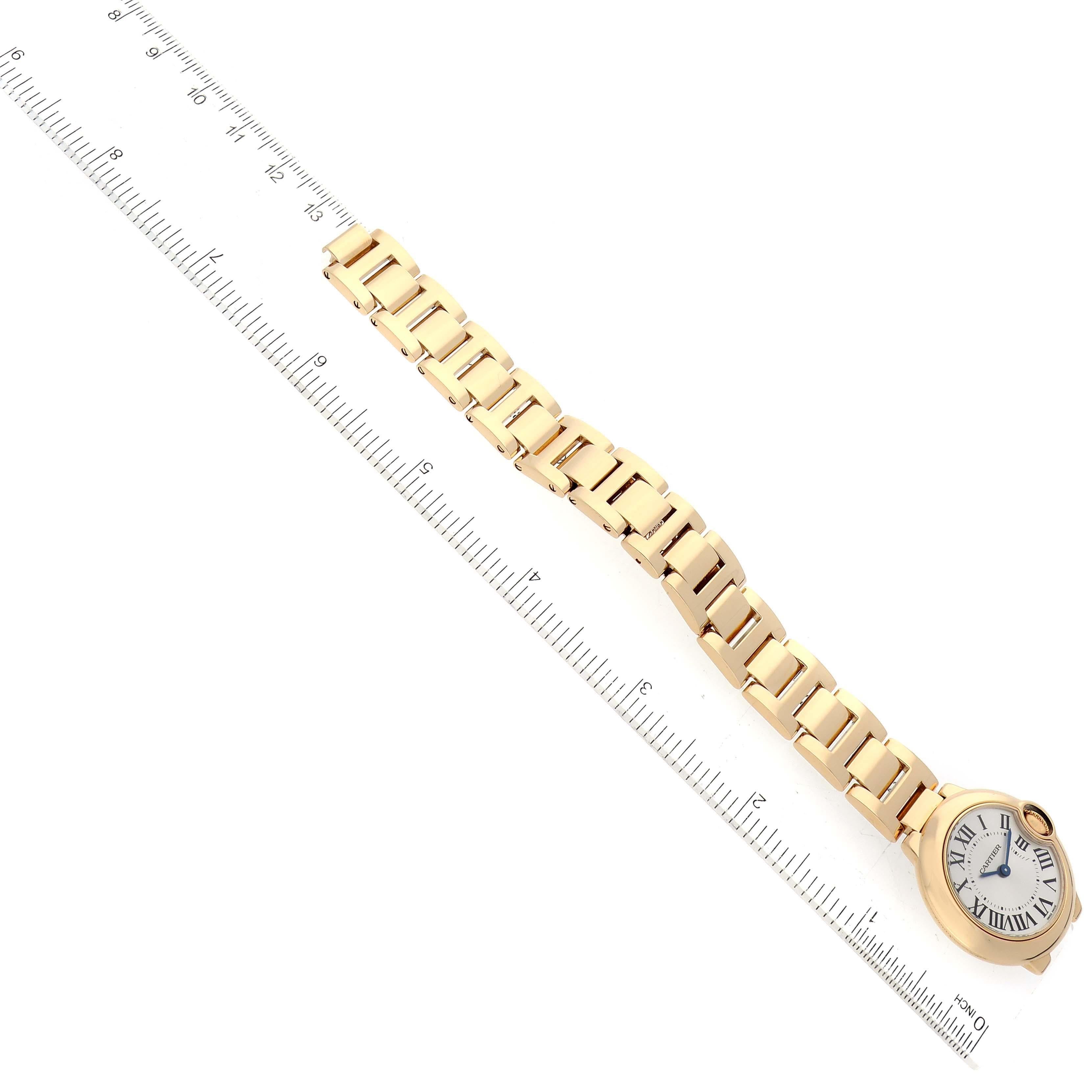 Cartier Ballon Bleu Yellow Gold Ladies Watch W69001Z2. Quartz movement. Caliber 057. Round 18K yellow gold case 28 mm in diameter. Fluted crown set with a blue sapphire cabochon. . Scratch resistant sapphire crystal. Silver sunburst dial with Roman