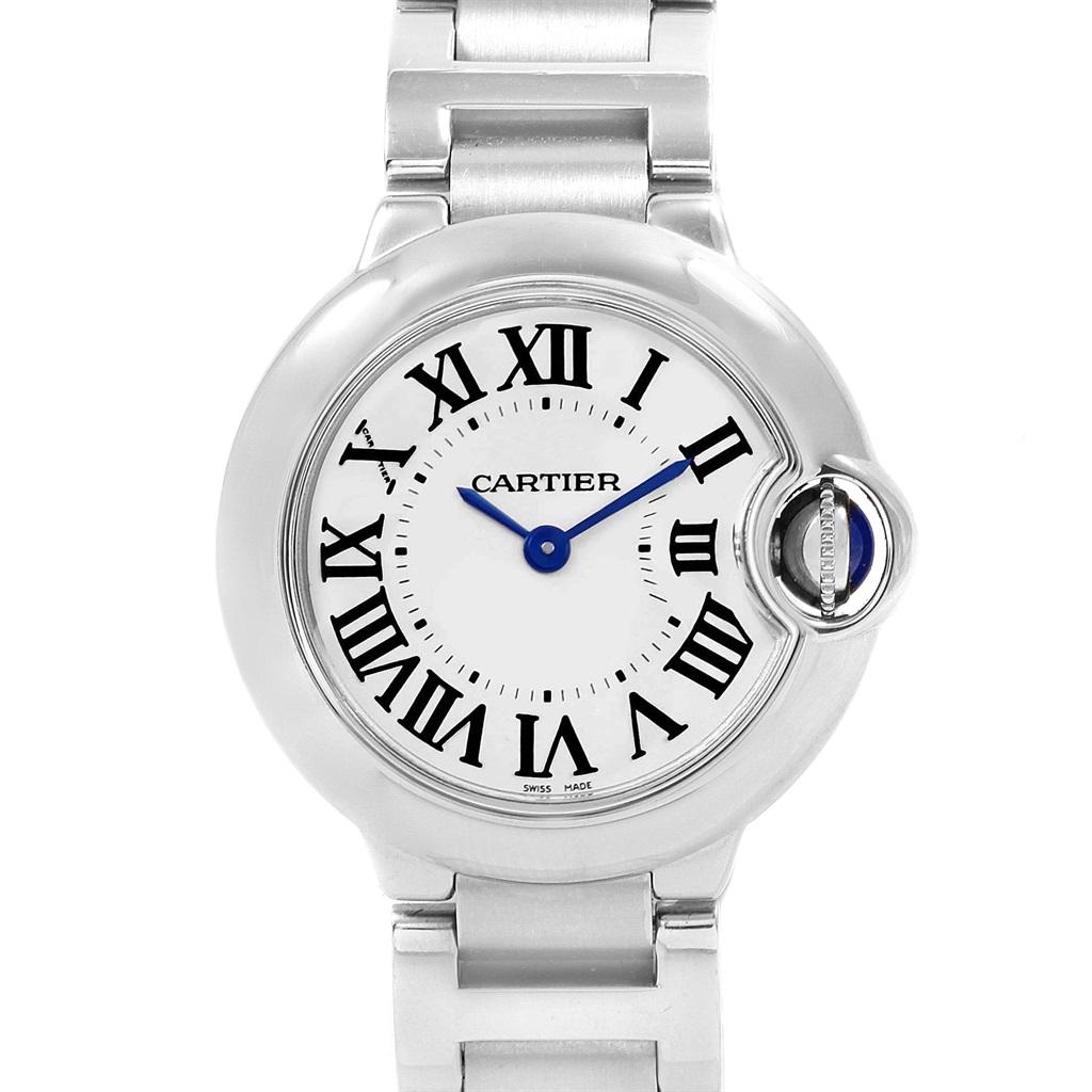 Cartier Ballon Blue 29 Silver Dial Blue Hands Ladies Watch W69010Z4. Quartz movement. Caliber 049. Round stainless steel case 29.0 mm in diameter. Fluted crown set with the blue spinel cabochon. Fixed stainless steel smooth bezel. Scratch resistant